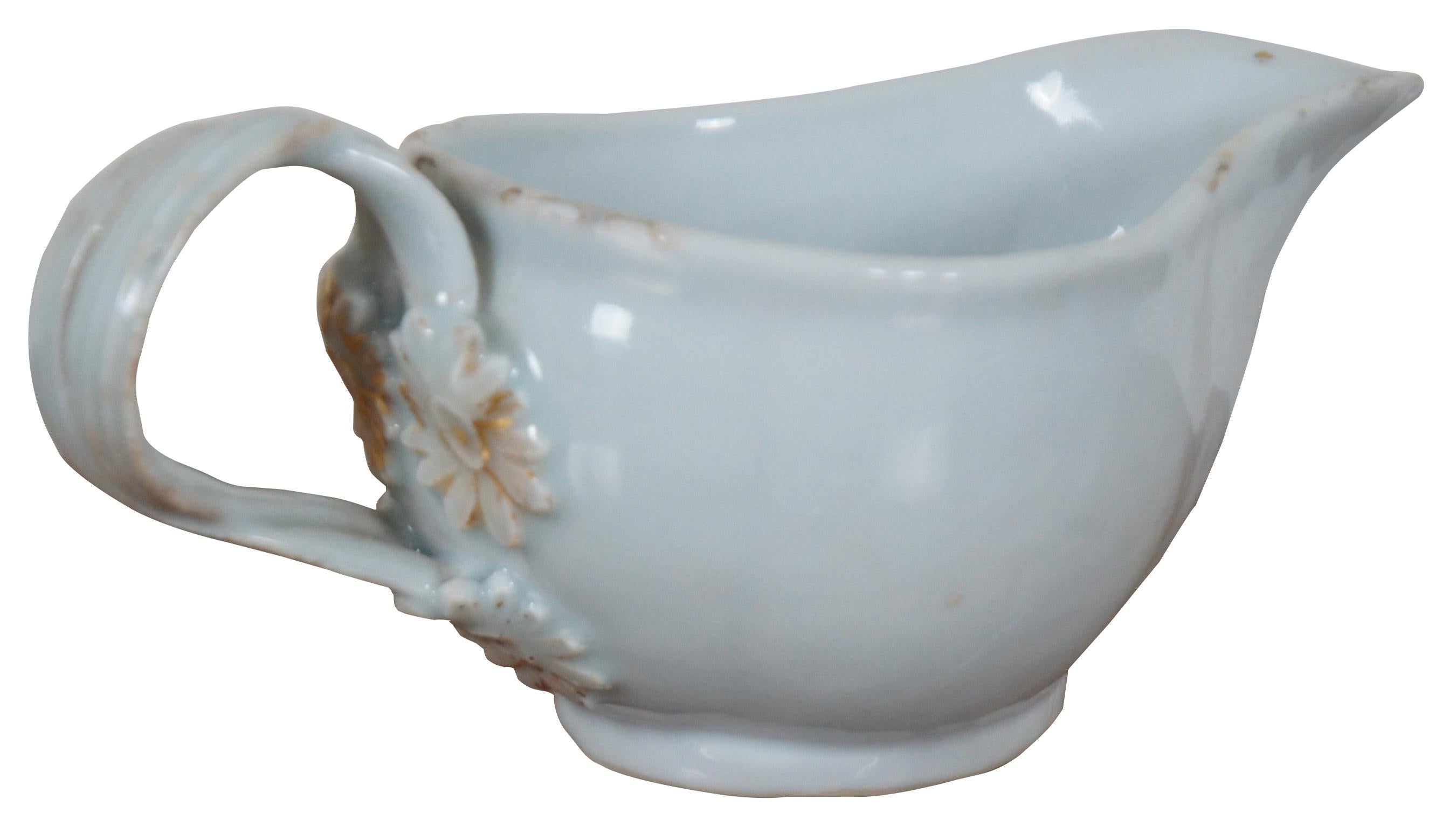 Antique 18th century Chinese Export (Qianlong Period, circa 1780) porcelain gravy boat or creamer with gilded accents and armorial coat of arms, finished in a pale blue tinted glaze. Measure: 7