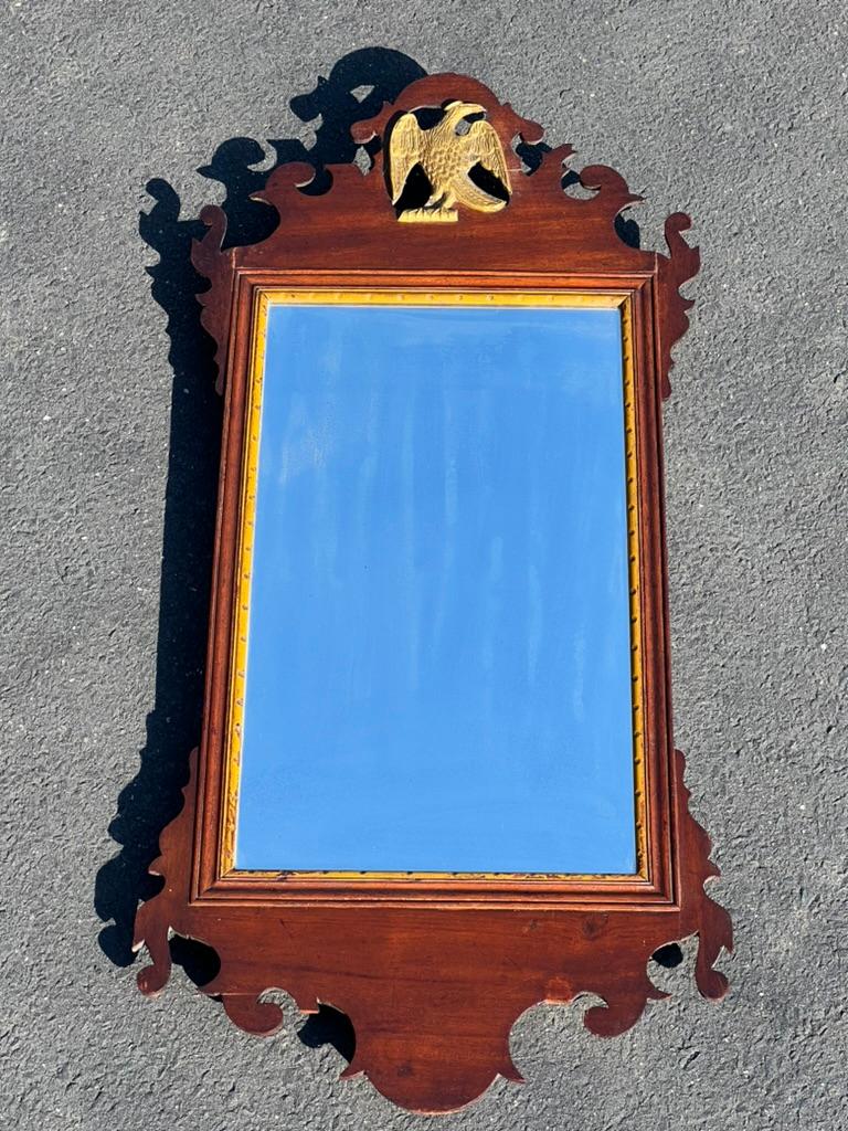 Introducing a stately Antique 18th Century Chippendale Wall Mirror with Eagle Crest, a magnificent piece that exudes historical charm and elegance. This mirror is perfect for adding a touch of grandeur to any room in your home.

Crafted from rich