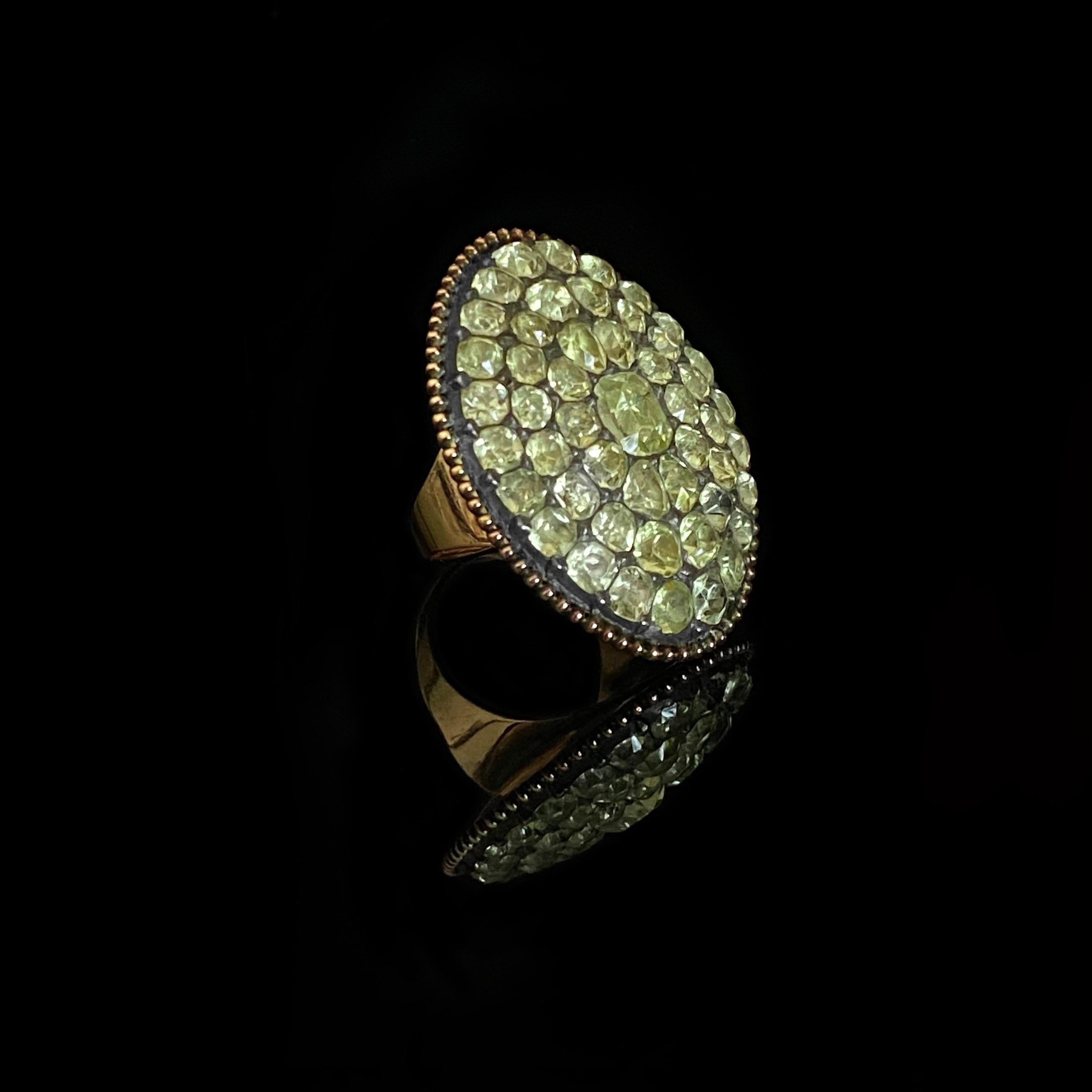 Antique 18th Century Chrysolite Chrysoberyl Cocktail Ring in Silver Gilt and Rose Gold, Portugal, c. 1780. This rare Portuguese jewel is designed as a moval (mix of marquise/navette and oval) shape cluster ring pave-set throughout with old-cut
