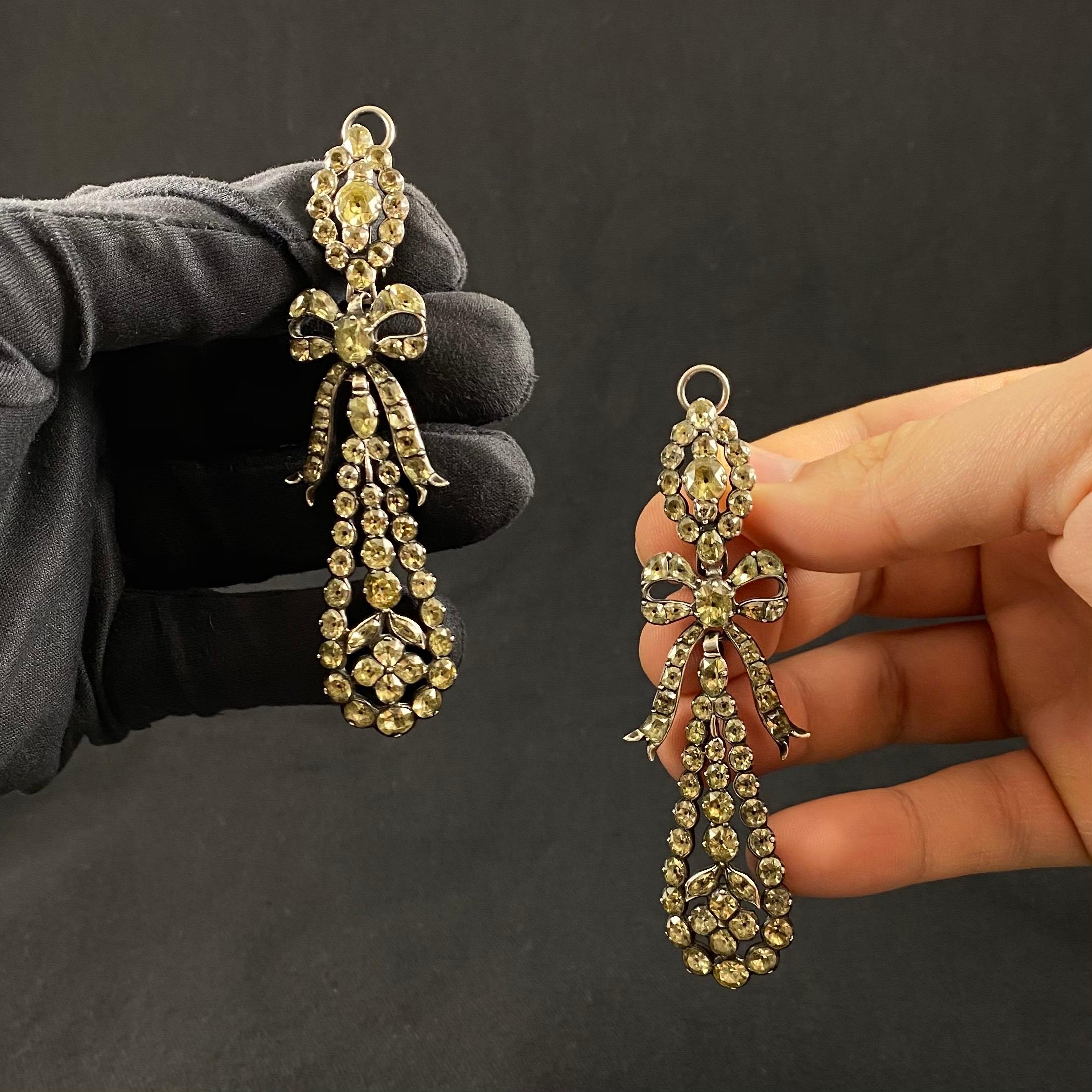 Museum Quality Antique 18th Century Chrysolite Chrysoberyl Pendeloque Pendant Earrings, Portugal, c. 1780. Each earring of an openwork design with a navette shape cluster top suspending a ribbon tied bow and hung with a flowerhead in tear-drop