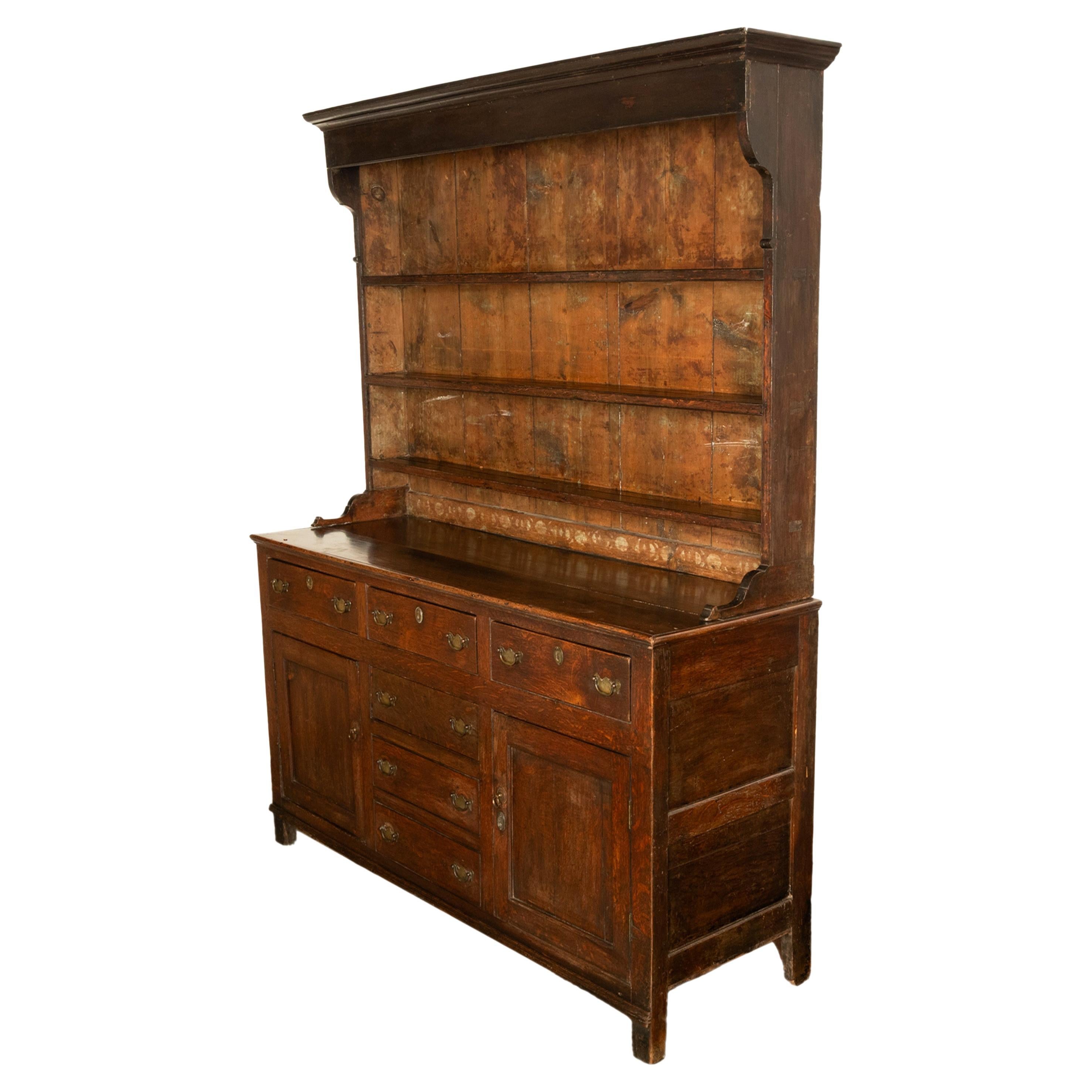 A good antique Georgian oak Welsh dresser & plate rack, Cardigan, Mid Wales, circa 1780.
The dresser is in two sections, above is a plate rack with a stepped cornice and having three shelves, to display plates or ? The base with three drawers along
