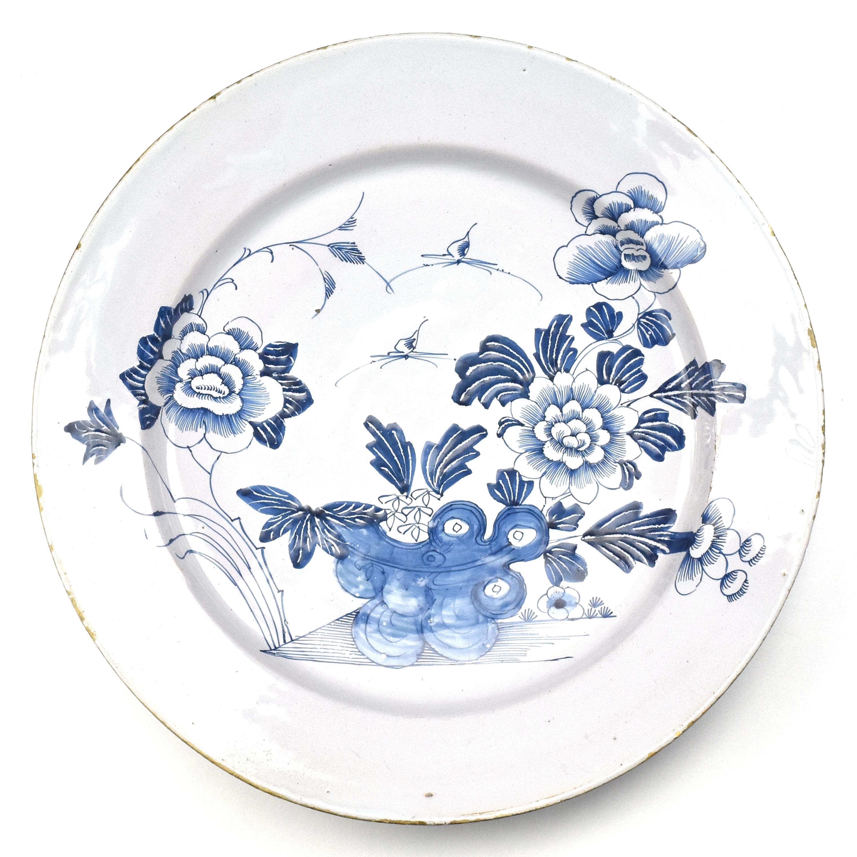 This antique 18th Century Dutch Delft Chinoserie plate is a captivating piece of ceramic art that reflects the outstanding craftsmanship and cultural exchange of its time. Originating from the 18th century Dutch Delftware tradition, this plate is a
