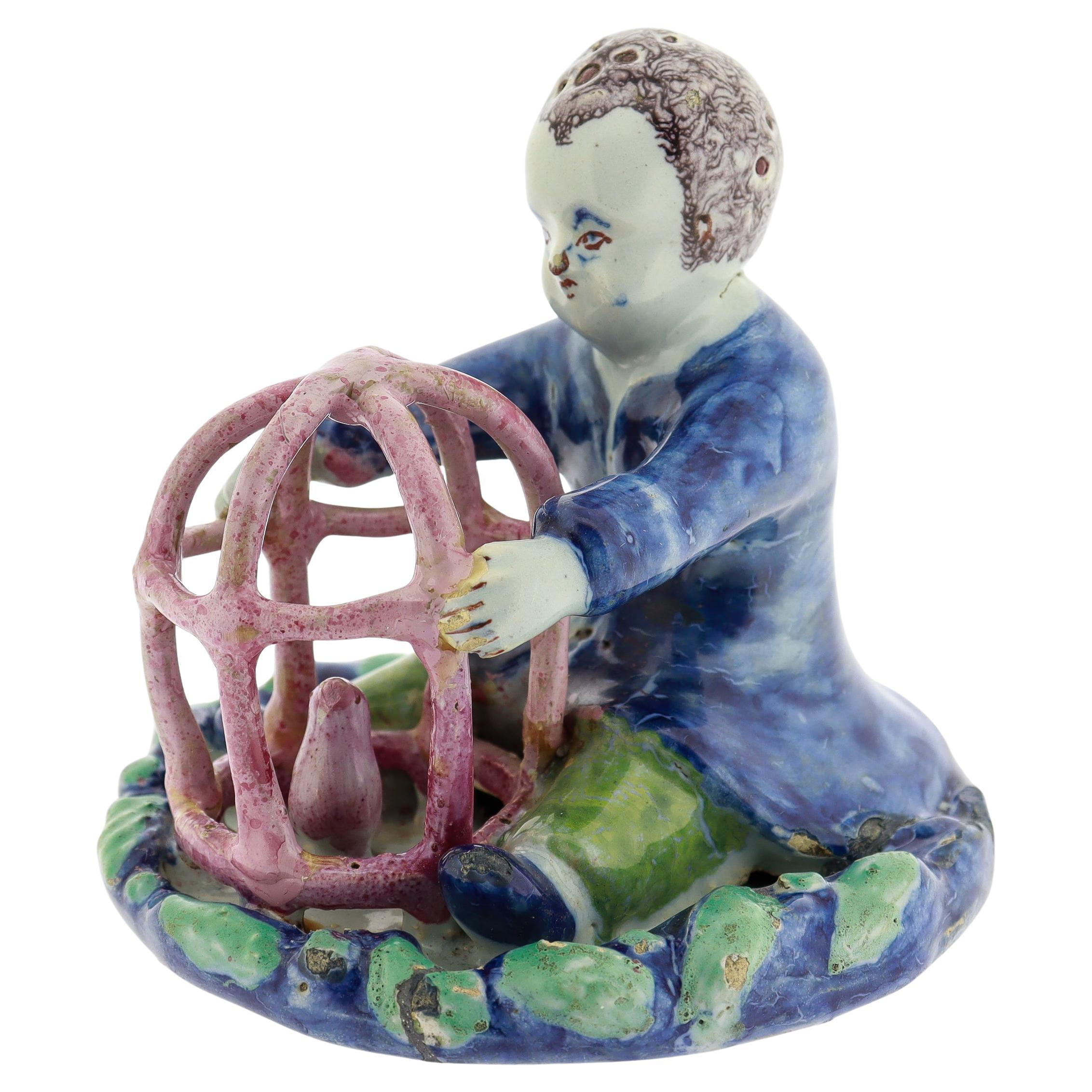 Antique 18th Century Dutch Delft Figurine of a Boy holding a Birdcage with Bird