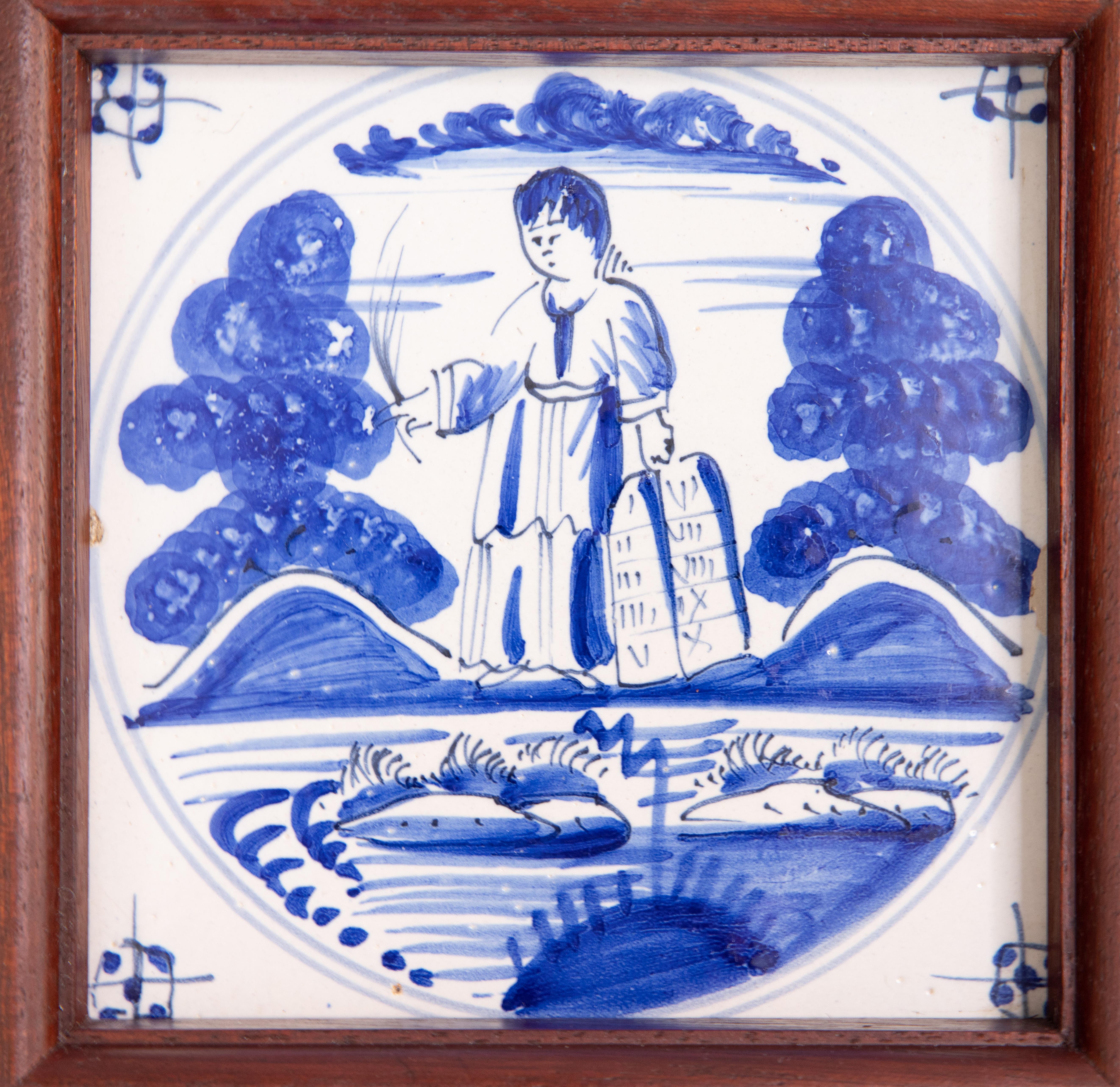 A superb antique 18th-Century Dutch Delft hand painted tile in a custom mahogany wood frame, circa 1750. This fine tile depicts a biblical figure, Moses with the Ten Commandments, in vibrant cobalt blue paint and is in amazing condition considering