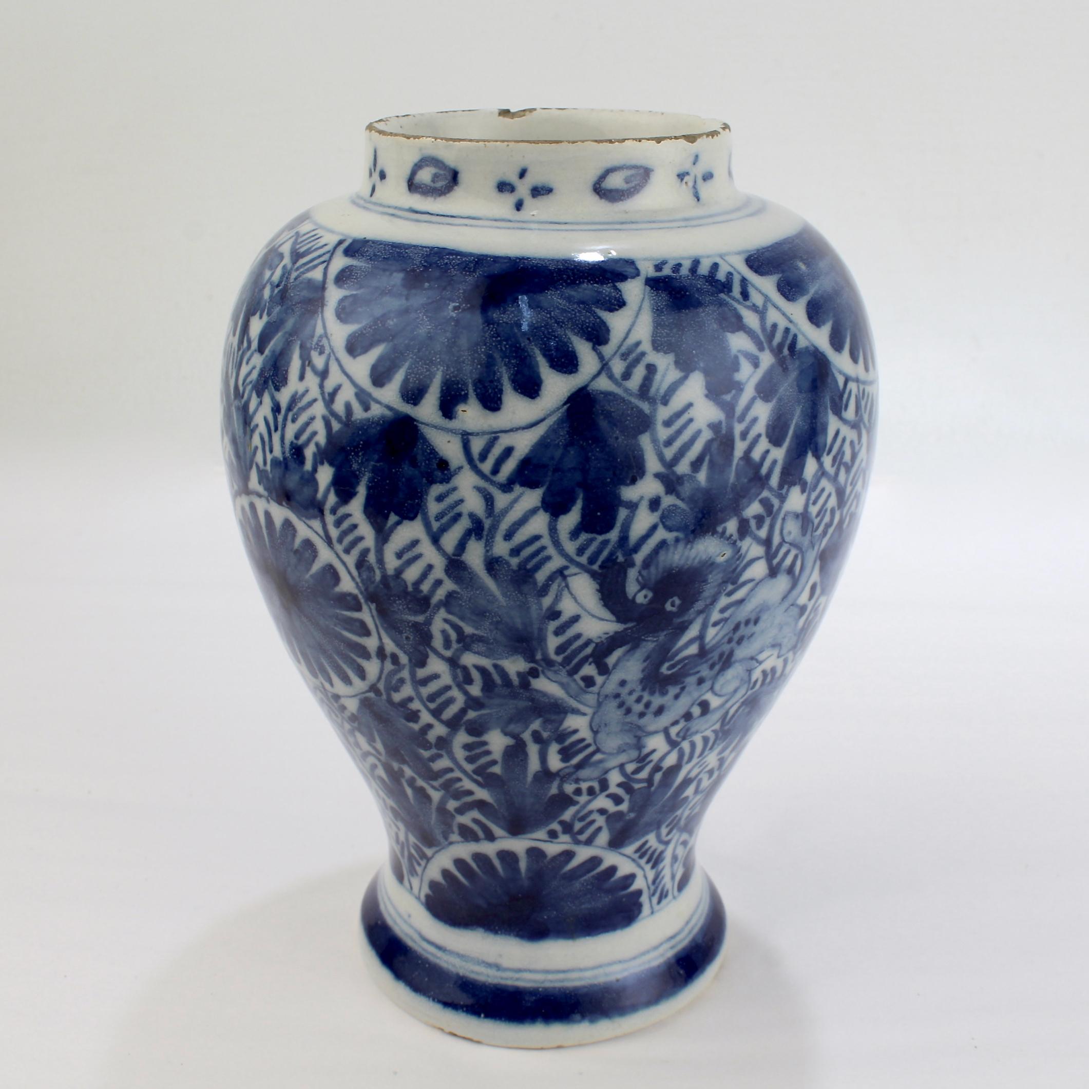 A fine antique Dutch Delft pottery jar.

The tin glazed vasi-form jar is richly decorated with blue underglaze flowers and foliage.

It also has a stylized dragon to the front and reverse. The base is unmarked.

Simply a fine diminutive