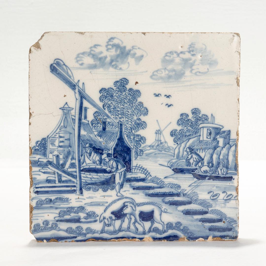 A fine antique 18th century Dutch Delft pottery tile.

Depicting a landscapre with sheep & pigs in the foreground, a central farm along a canal, and a windmill in the background.

Simply a wonderful antique Dutch Delft tile!

Date:
18th