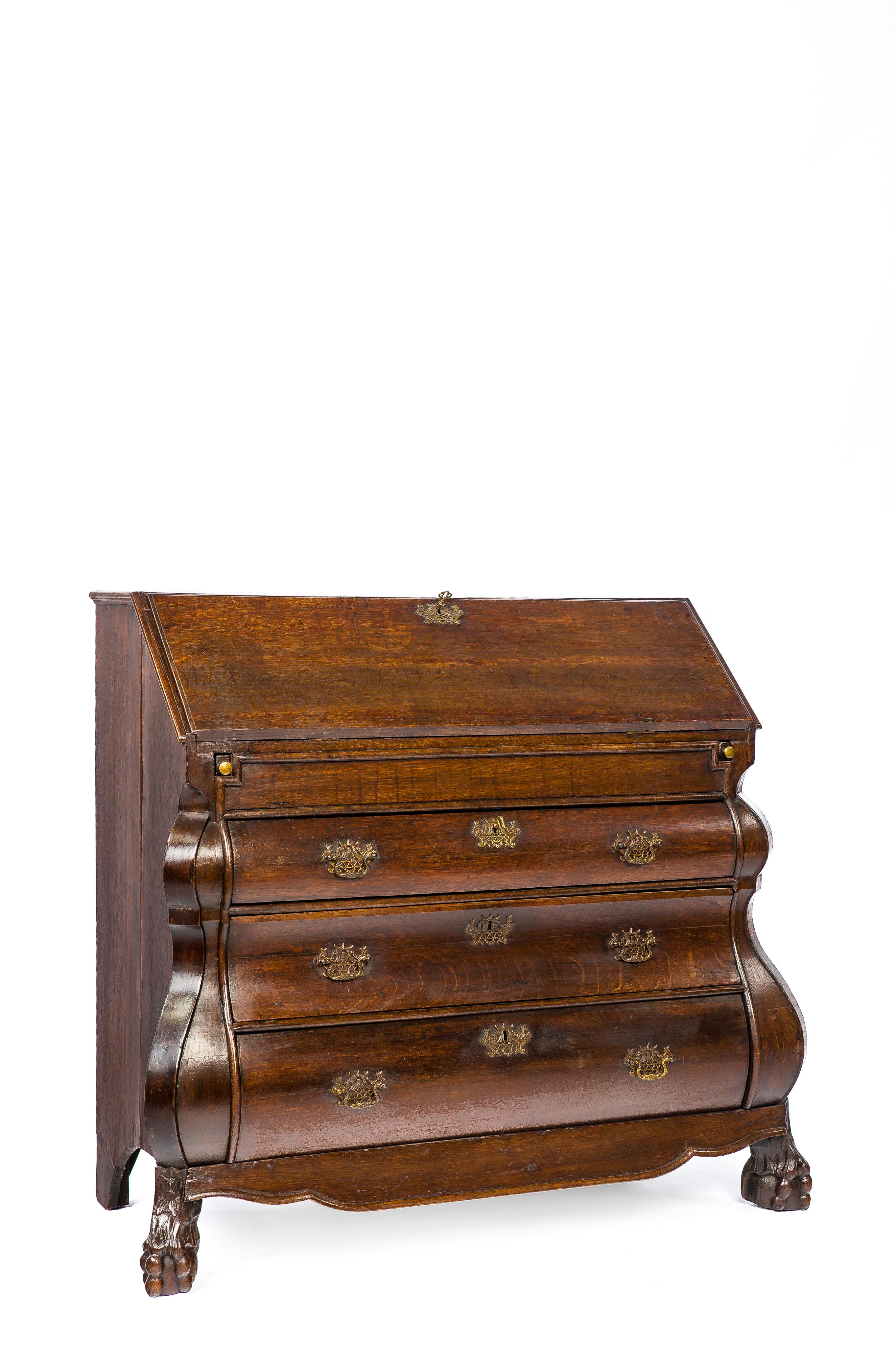 A beautiful Dutch Baroque style secretary with a 3-drawer bombe front and carved ball and claw feet.
The drop front opens up to reveal an oak writing area and stepped drawers. This compartment is centered upon a lockable door with a hidden drawer