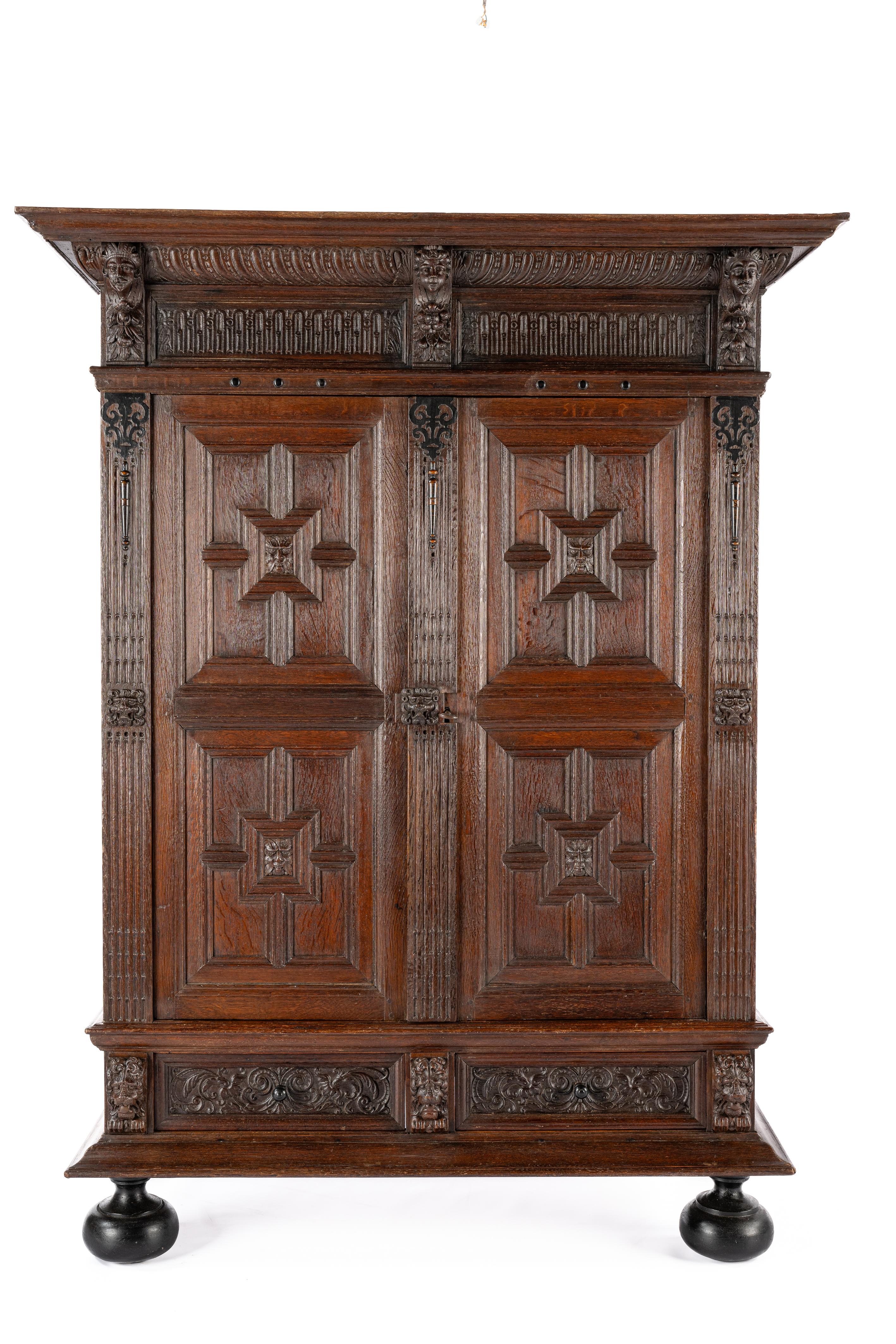 This antique Dutch Renaissance cabinet was crafted in the southern Netherlands at the end of the 18th century, around 1780. It serves as a quintessential example of the furniture craftsmanship during the Dutch Golden Age. Constructed from the finest