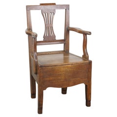 Antique 18th-century English oak armchair with armrests and an ornament