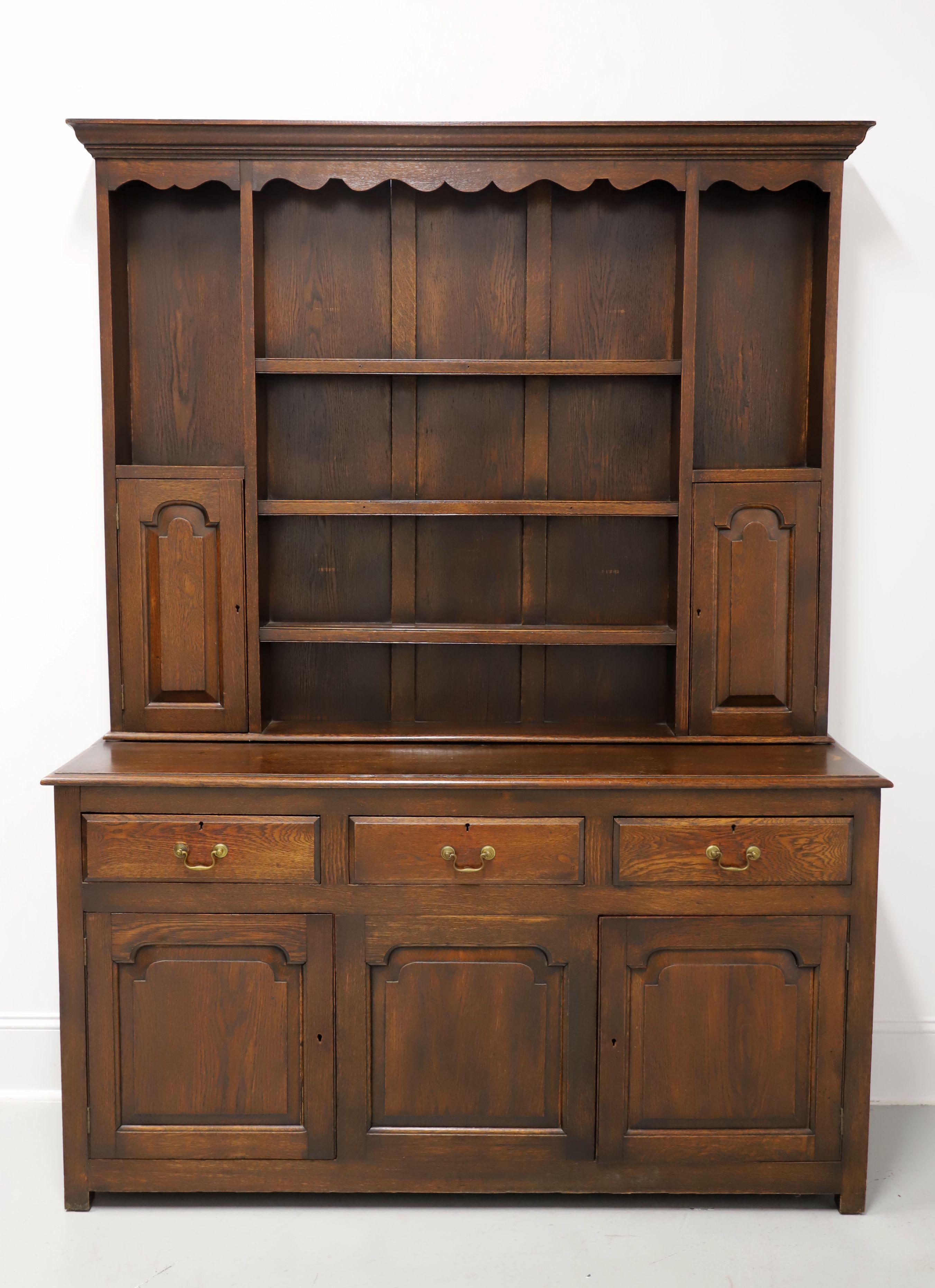 An antique 18th Century pewter cupboard in the William & Mary style, unbranded. Solid oak, brass hardware, top cabinet finished with crown moulding & scalloped frieze, bevel edge to top of lower cabinet, and short square straight legs. Upper portion