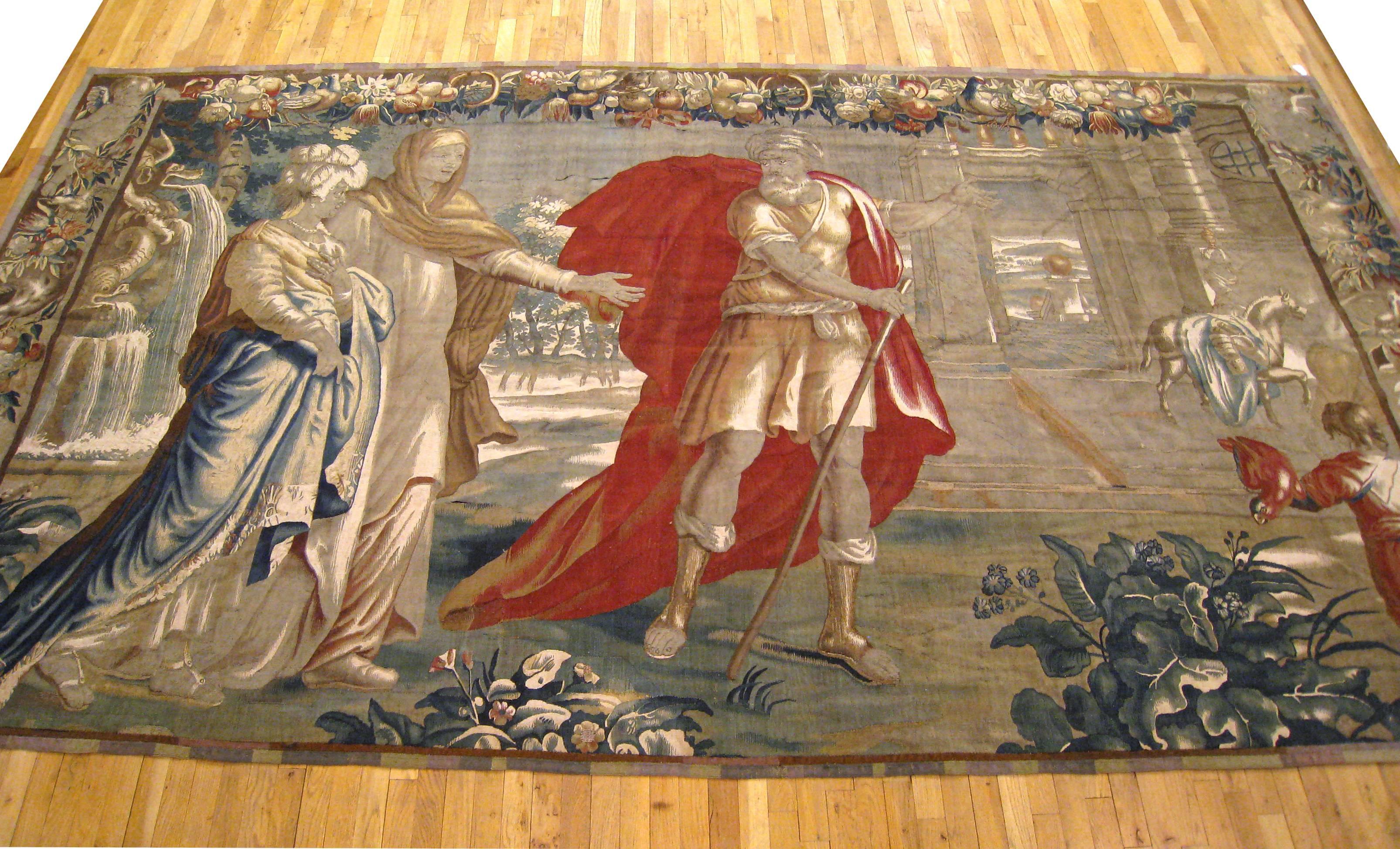 An antique 18th century Flemish Historical Tapestry, size 7'8 H x 13'4 W. This period European tapestry depicts the Roman general, Coriolanus, being pleaded with by his wife Virgilia and his mother Volumnia as he prepares to return to the