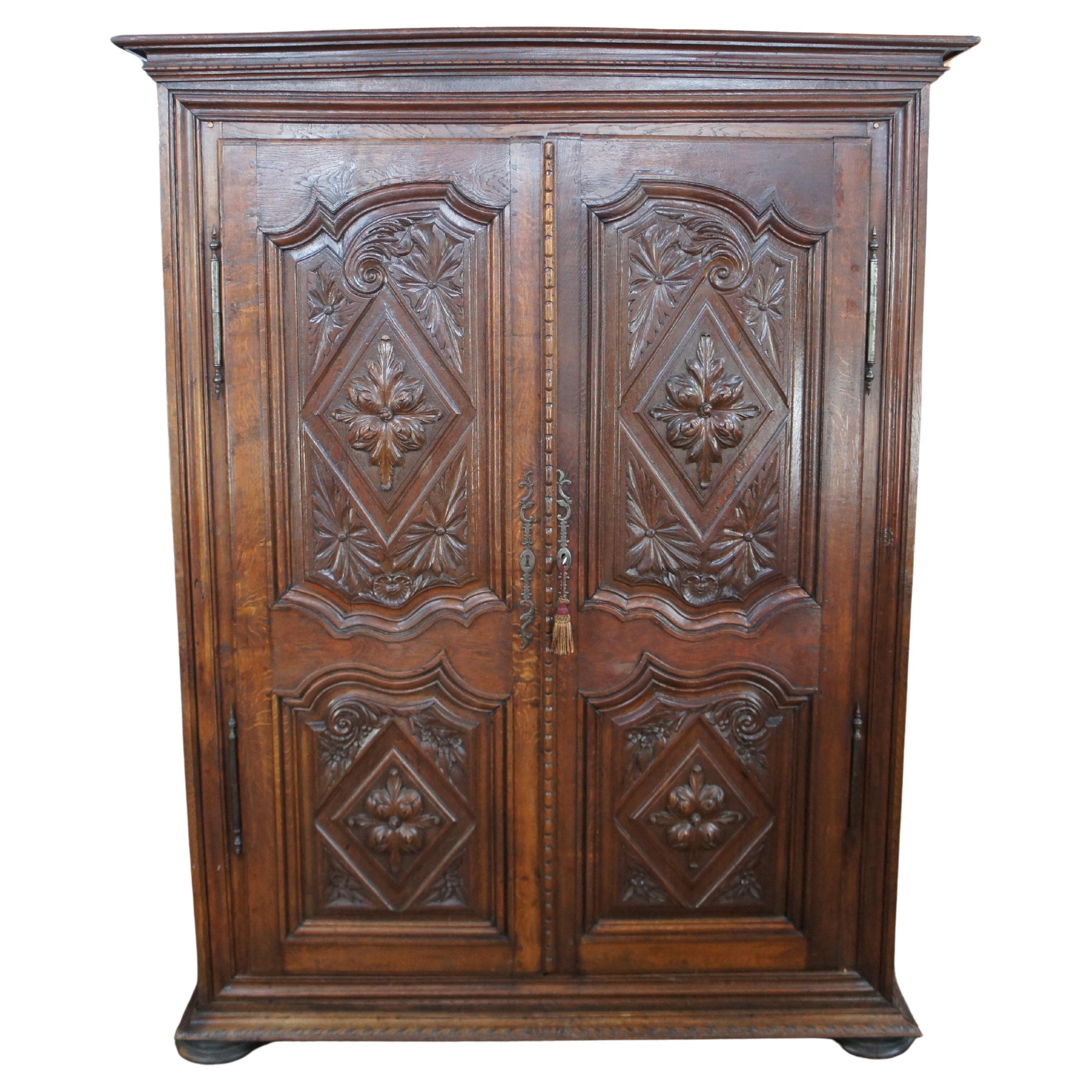 An exceptional 18th century French Knockdown Armoire.  Made from oak with beautifully hand carved inset paneled doors featuring diamonds, French foliate and scrolling wing motifs.  The cabinet opens to shelving which can be removed to allow access