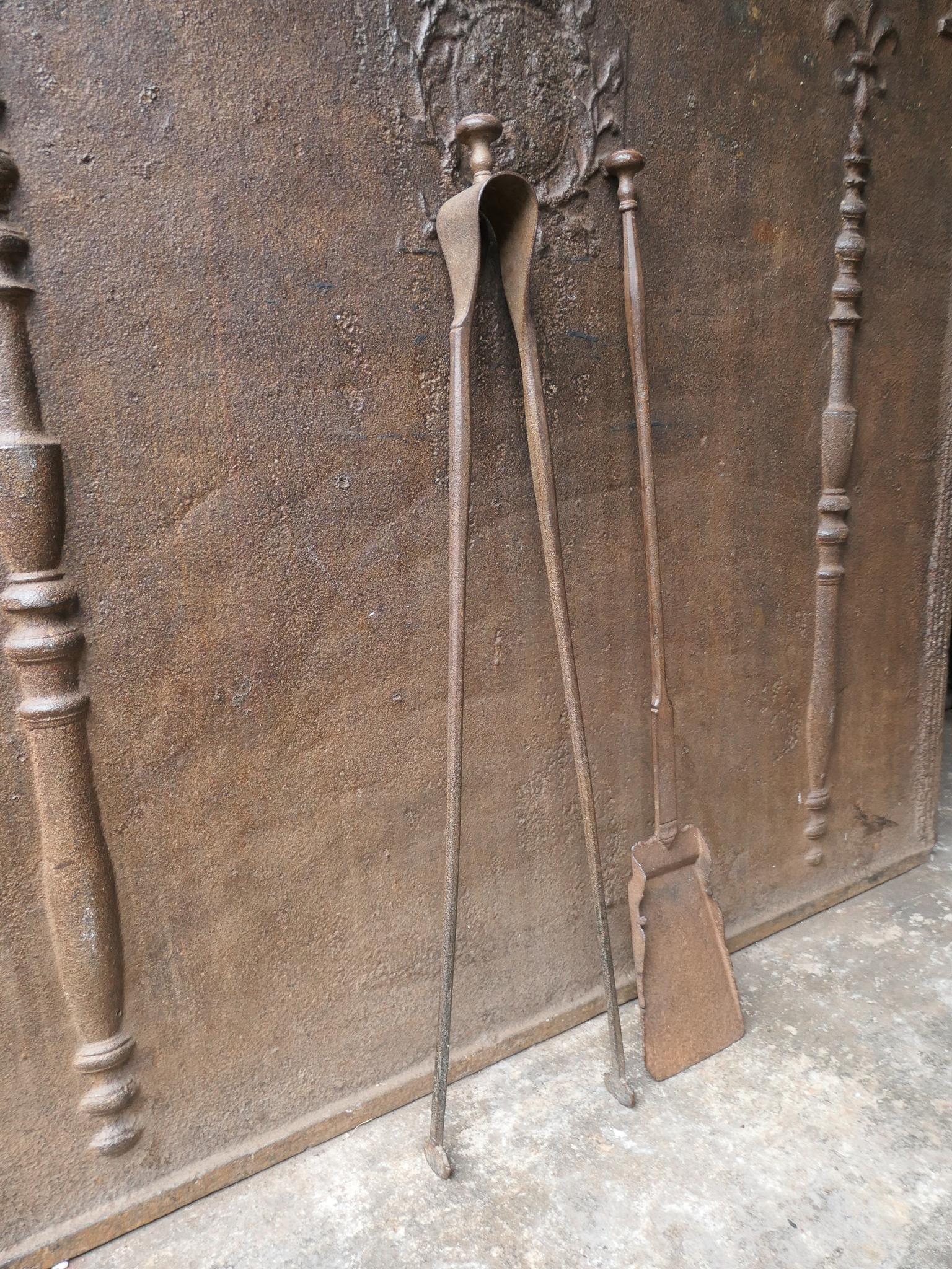 Antique 18th century French Louis XV period fireside companion set. The tool set consists of tongs and shovel. Made of wrought iron. It is in a good condition and is fully functional.