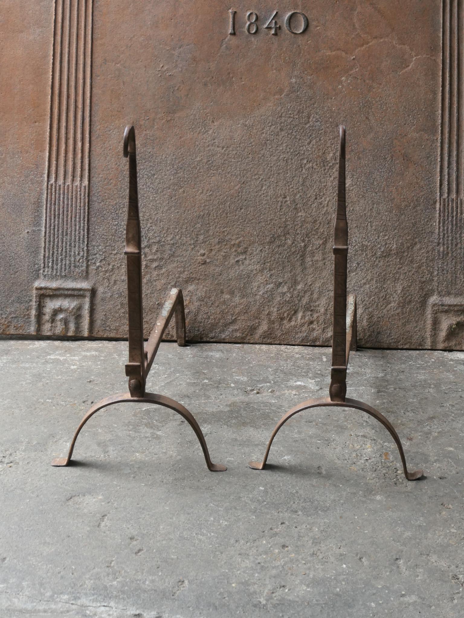 18th Century French Louis XV period andirons. Made of wrought iron. The andirons have spit hooks on which a spit can be put for cooking. The andirons are in a good condition and are fully functional.