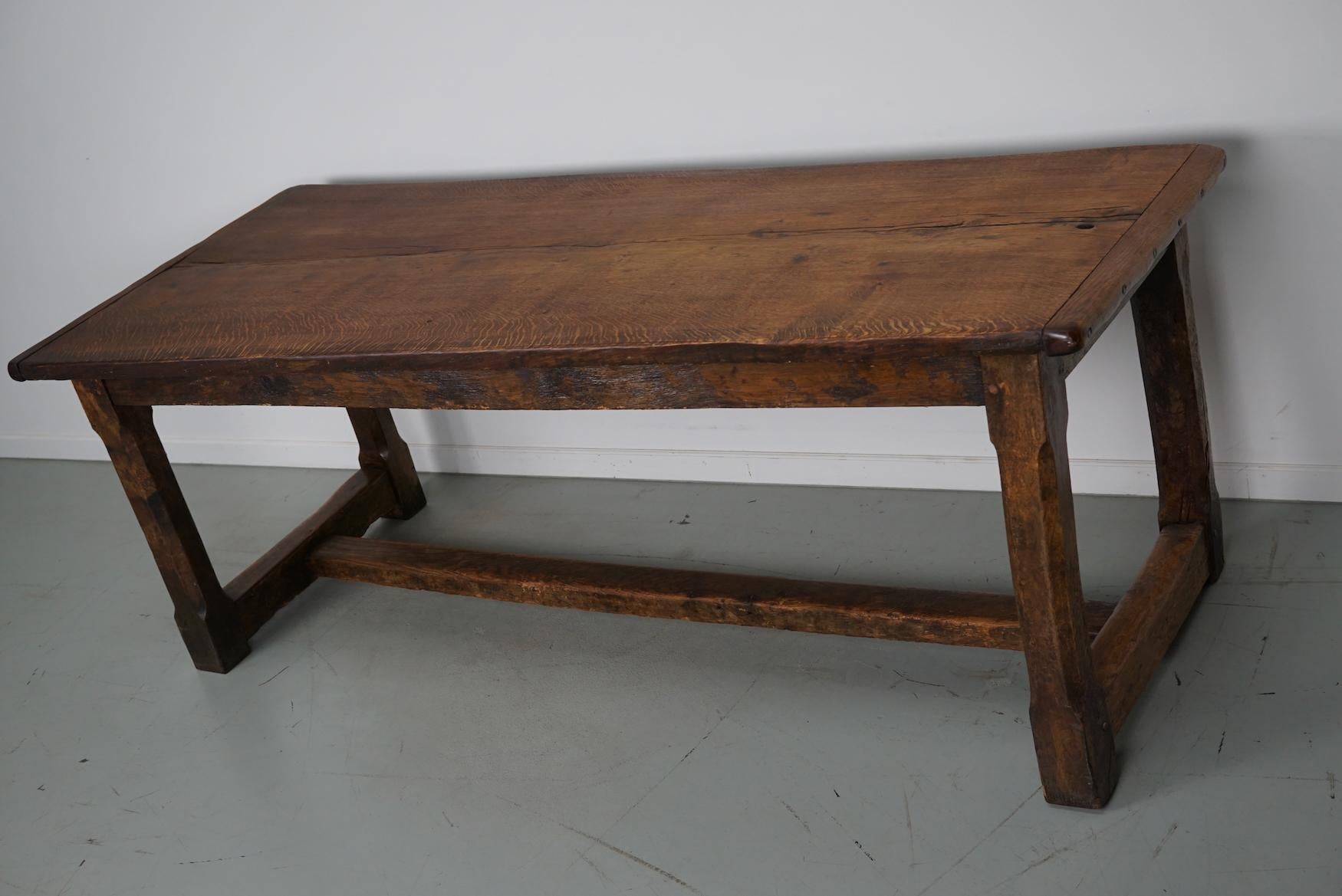 This elegant table was made in Southern France in the 18th century. It has a tabletop made from one large slab of tiger oak. It has a very warm color and the table shows many marks of use, warping, old repairs and a has a great patina. The knee