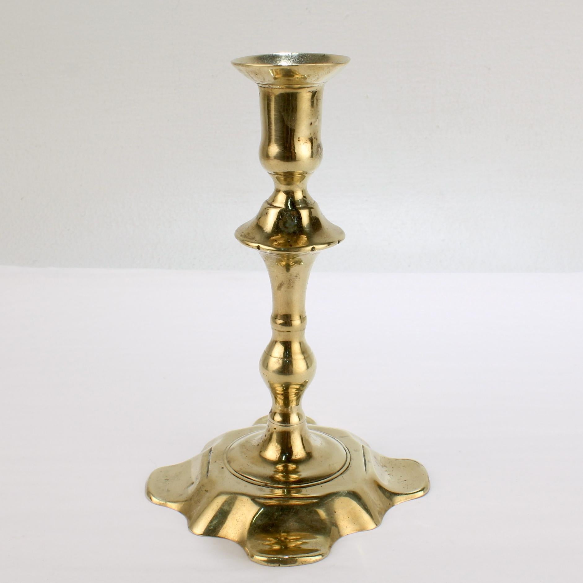 A fine antique English candlestick.

With a 8 lobed petal base, turned shaft, and integral bobeche. 

Simply a fine period candlestick!

Date:
Mid-18th century

Overall condition:
It is in overall good, as-pictured, used estate condition.