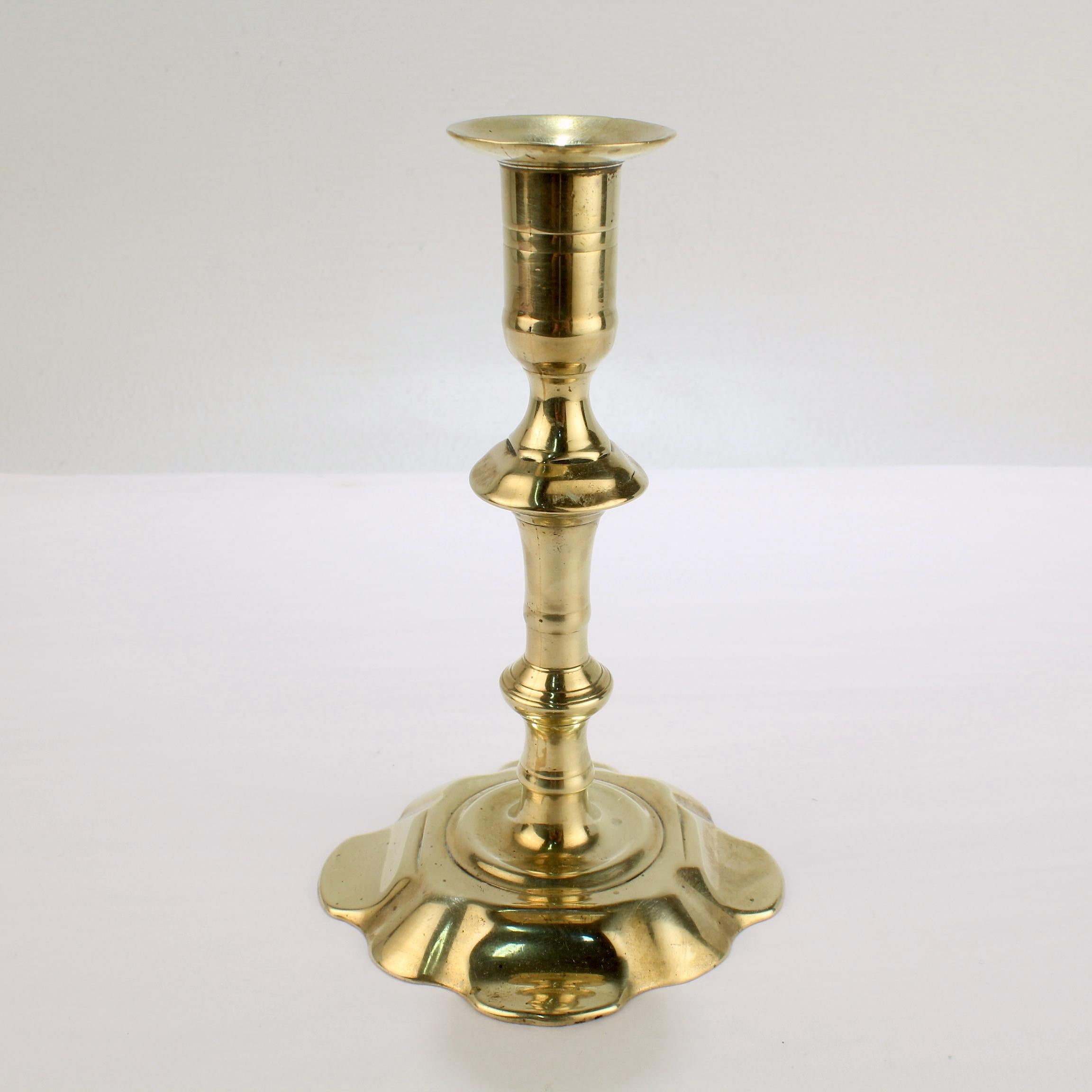 A fine antique English candlestick.

With a 8 lobed petal base, turned shaft, and integral bobeche. 

Simply a fine period candlestick!

Date:
Mid-18th century

Overall condition:
It is in overall good, as-pictured, used estate condition.