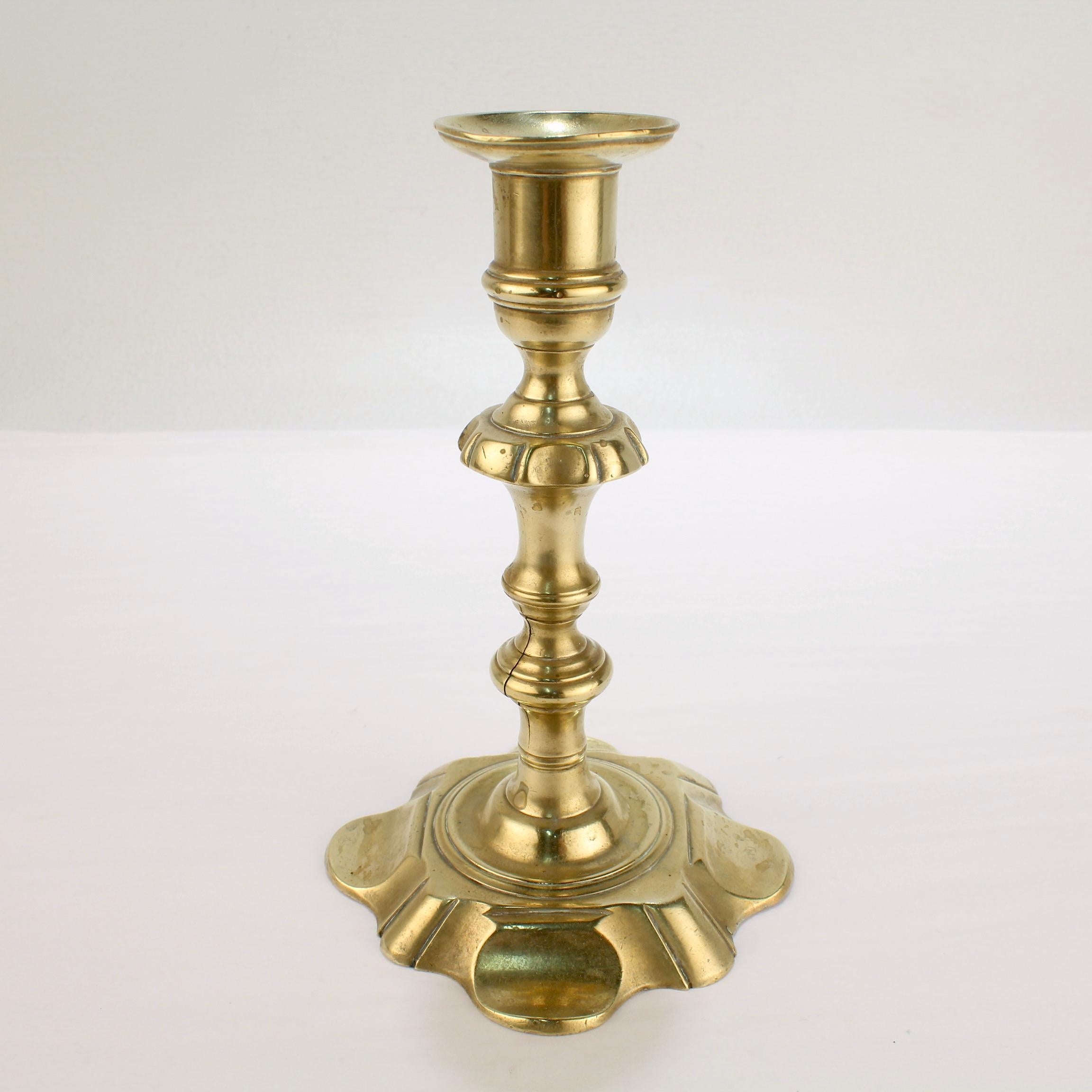 A fine antique George II English candlestick.

With a 8 lobed petal base, turned shaft, and integral bobeche. 

Simply a fine period candlestick!

Date:
Mid-18th century

Overall condition:
It is in overall fair, as-pictured, used estate