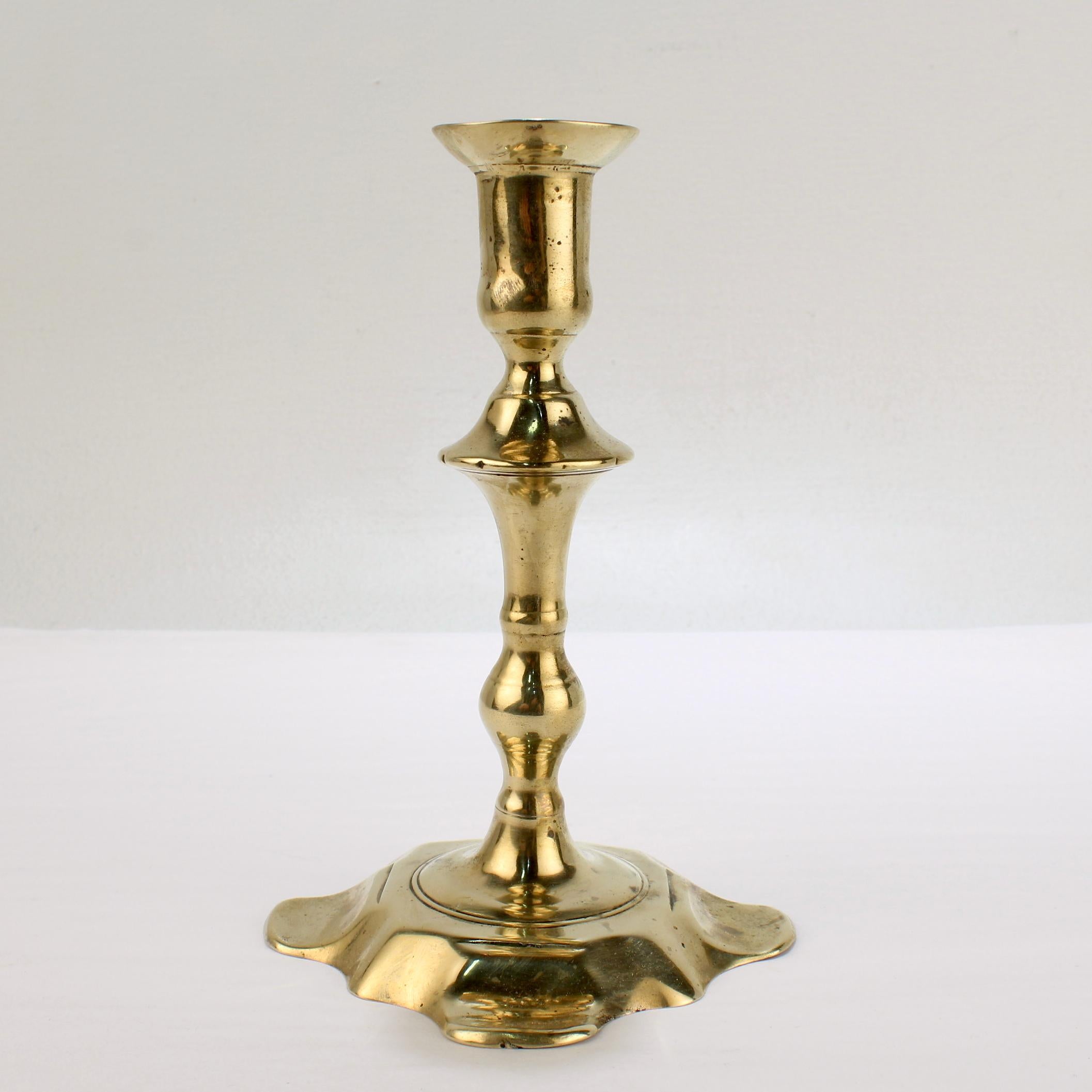 Antique 18th Century George II English Brass Petal Base Single Candlestick In Good Condition For Sale In Philadelphia, PA