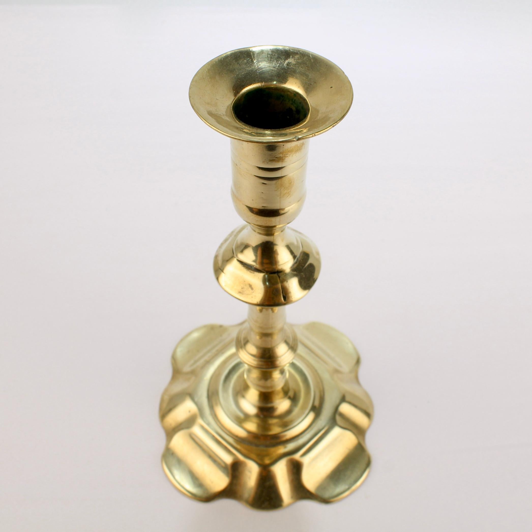 Antique 18th Century George II English Brass Petal Base Single Candlestick In Good Condition For Sale In Philadelphia, PA