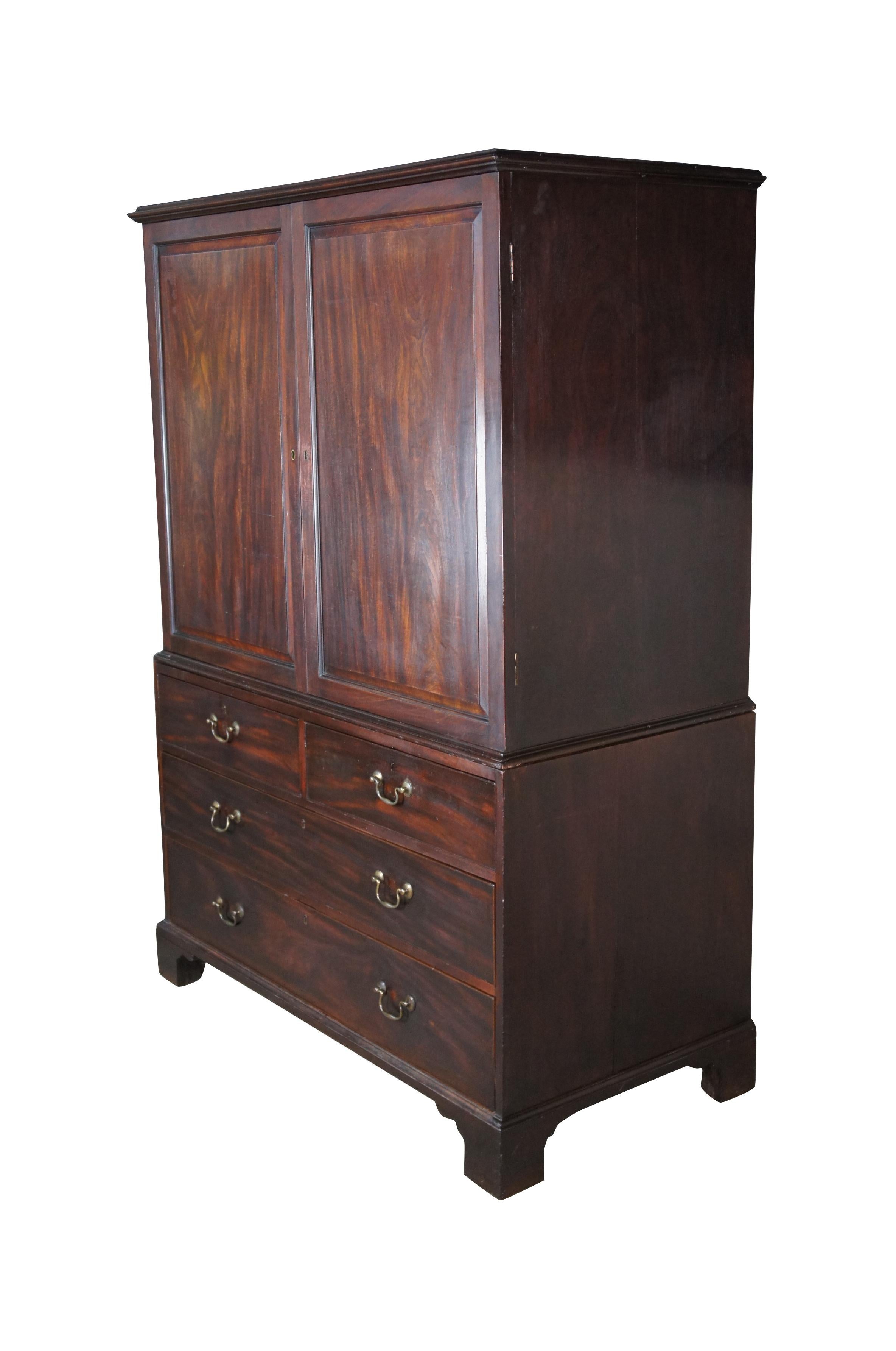18th Century George III Period Mahogany Linen Press.  A rectangular form with two over three hand dovetailed drawers and an upper closet / wardrobe with one large drawer and two pullouts for hangers.  The cabinet is accented by brass bale hardware