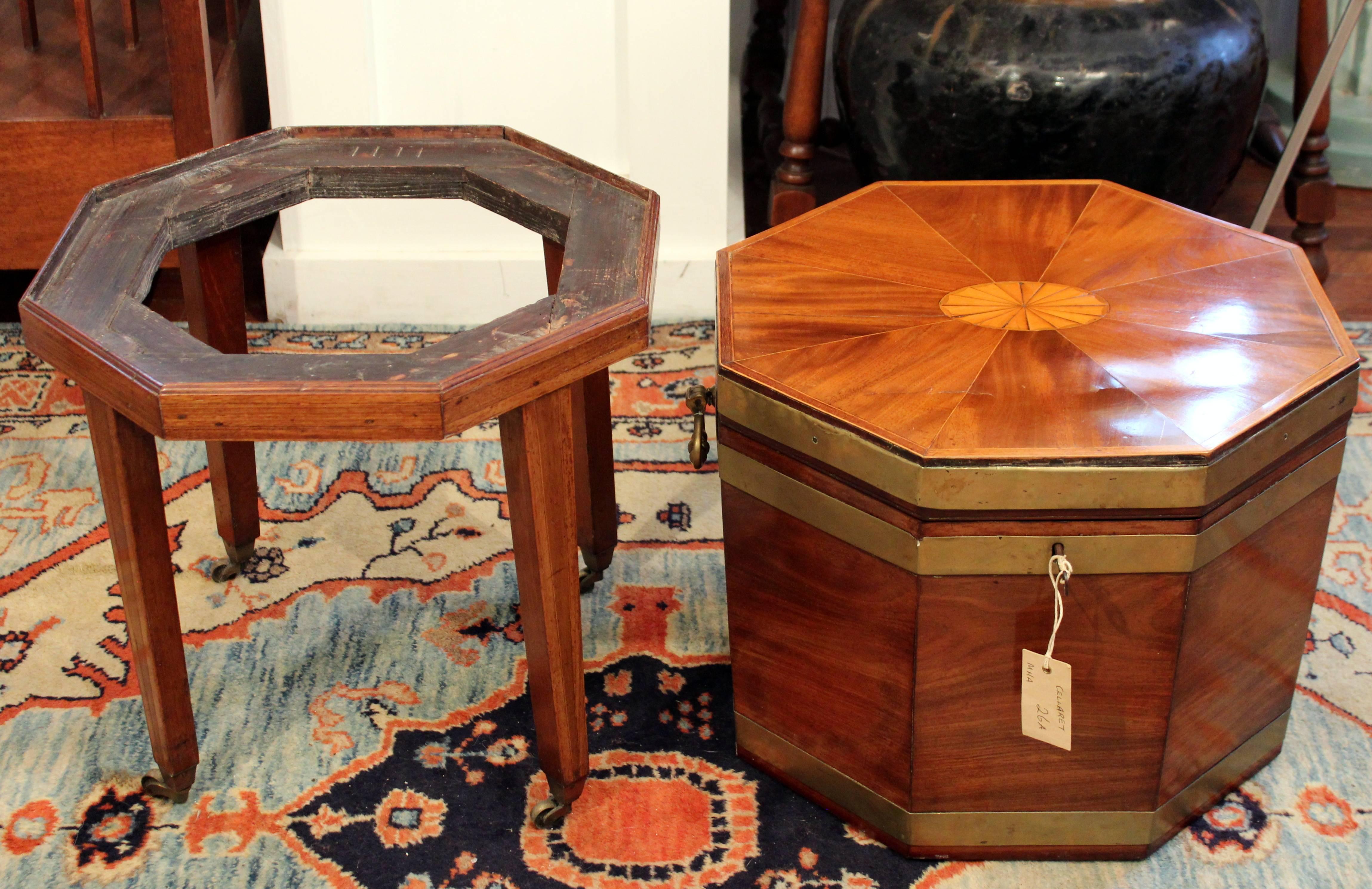 This superb quality George III inlaid satinwood and mahogany wine cooler features a more unusual octagonal shape with decorative brass banding, double hinge on the back, with original liner and cast brass lifting handles. It is supported on its