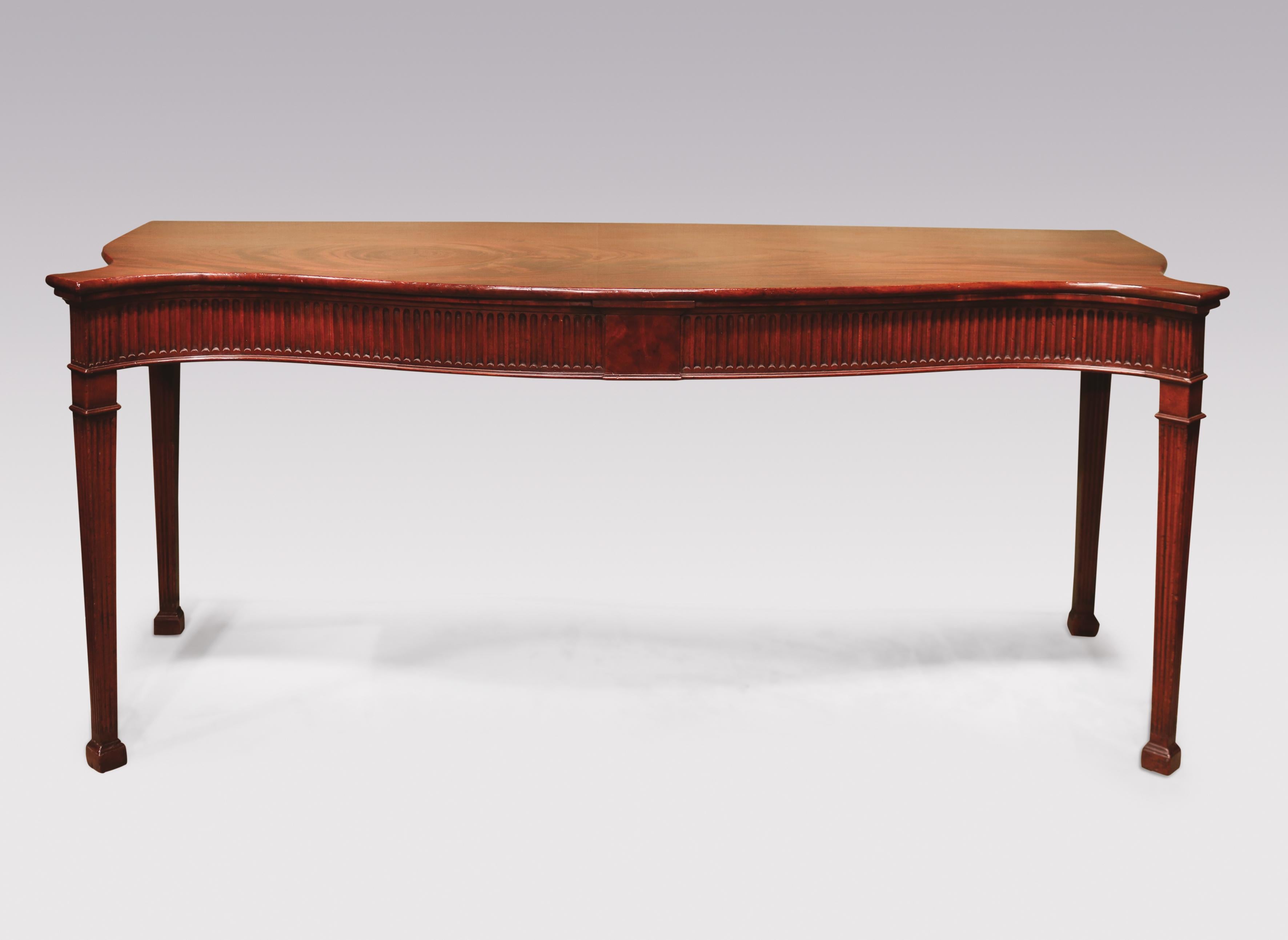 A fine mid-18th century George III period flame figured mahogany serving table, having canted cornered serpentine shaped front and sides, with fluted frieze and central panel below, supported on fluted tapering legs ending on block feet.