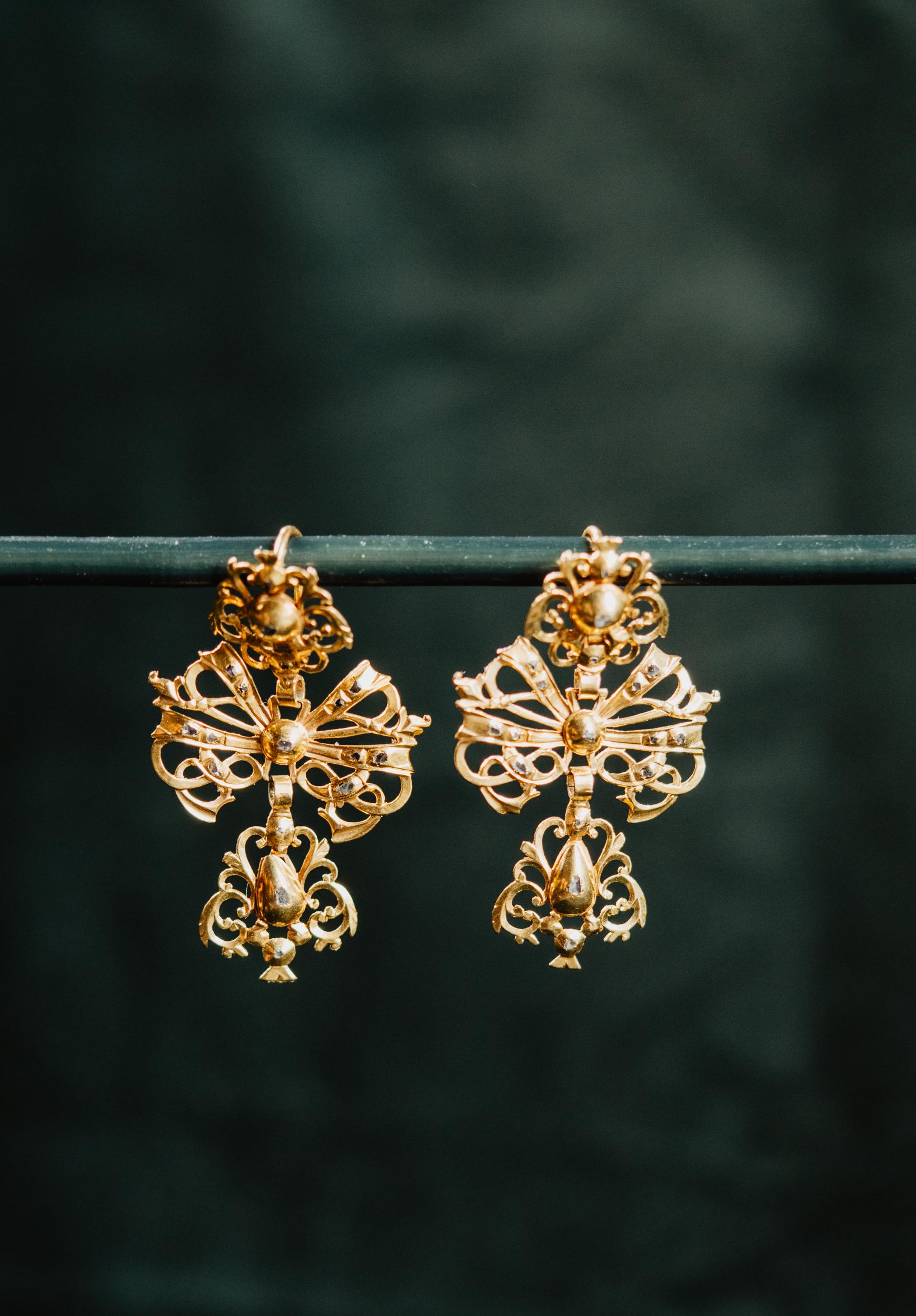 A museum-worthy 300 year old pair of solid 15k gold Iberian earrings! Coming from Madrid in Spain, these antique Georgian era high carat gold earrings are set with natural simplified cut diamonds.

The earrings are a perfect example of 18th century