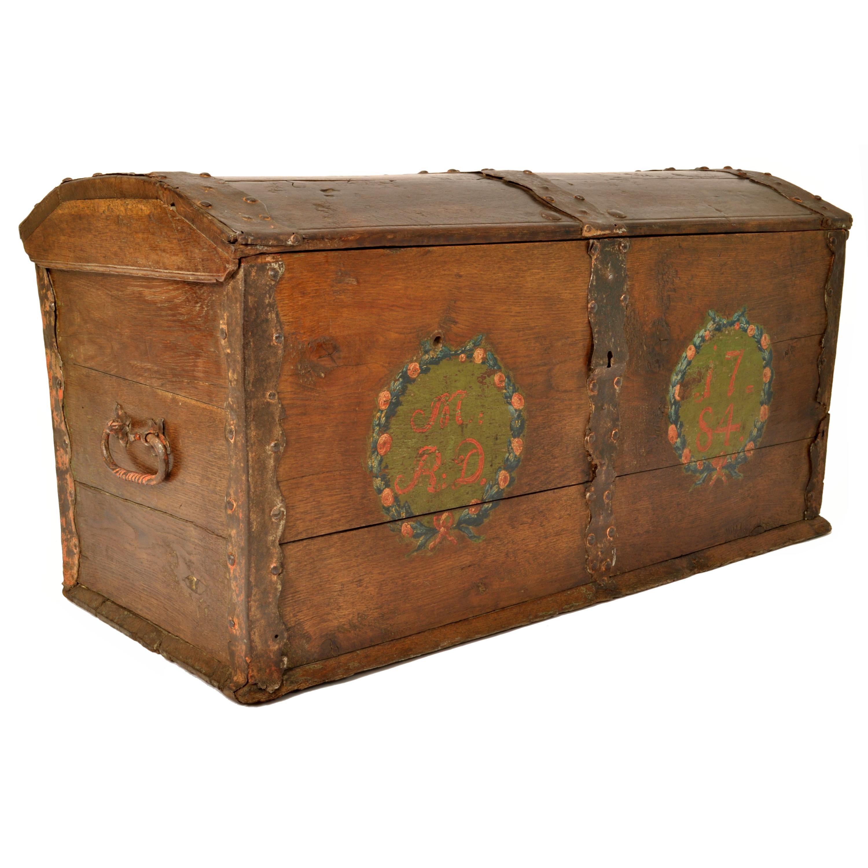 Antique German Baroque dome top painted walnut sea chest, dated 1784.
The chest having a hinged dome top with iron strapping, the interior of the lid having hand-forged strap hinges and original hand-forged iron lock and key, the interior of the