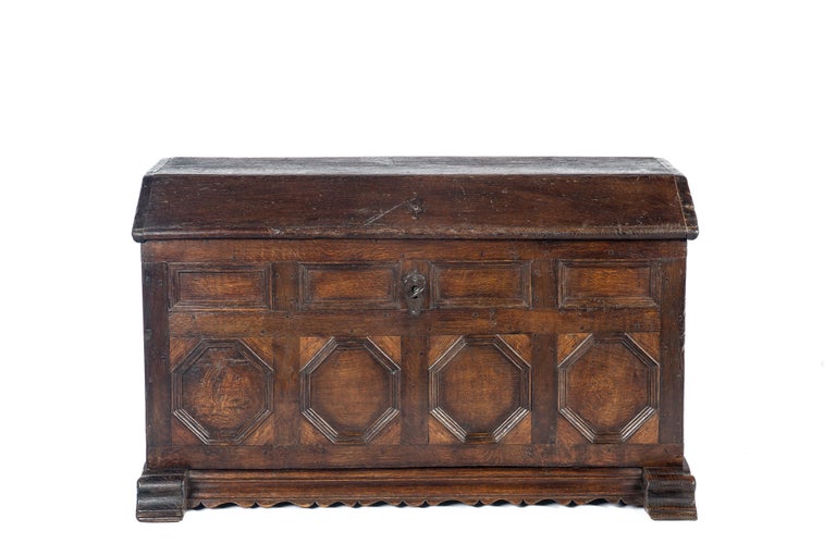 This beautiful trunk or chest was made in western Germany in the early 18th century. 
It was completely made in the finest quality watered oak and displays a beautiful wood grain pattern. The front of the chest features eight geometric recessed