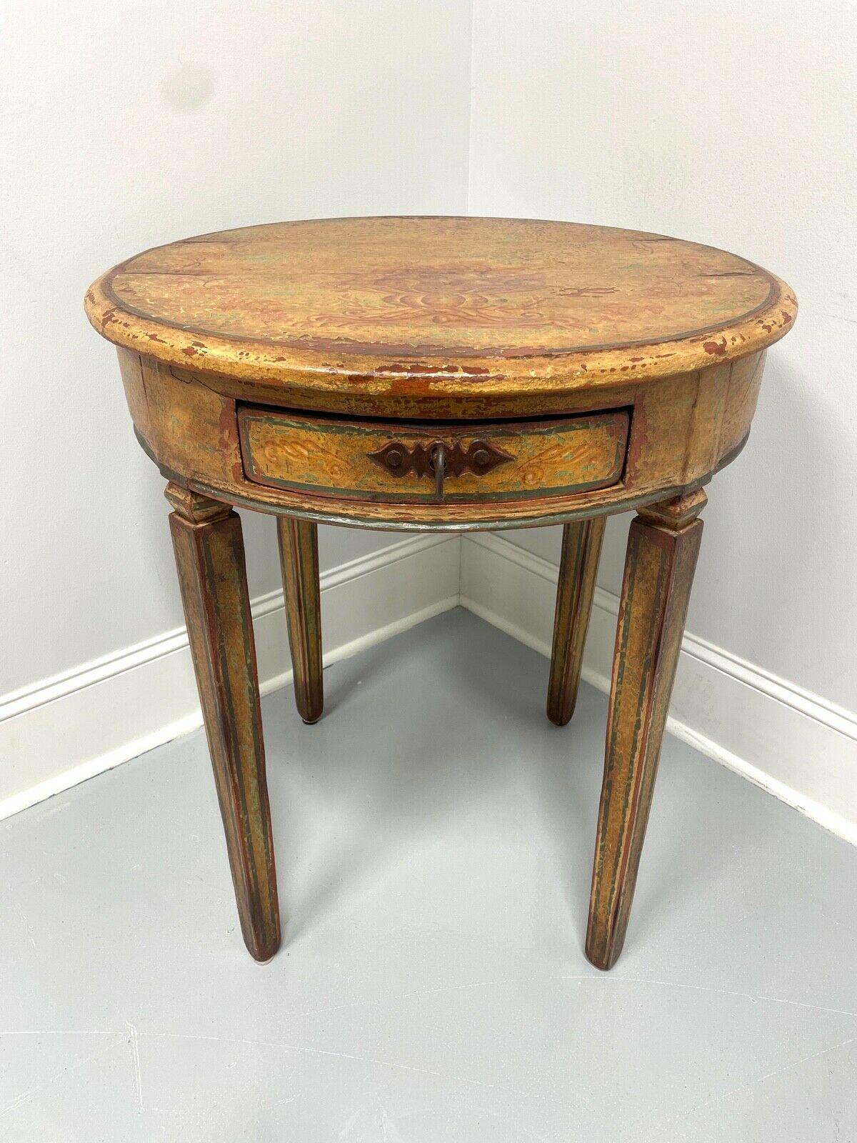 This antique 18th century round accent table has been painted and repainted over the years. The multiple layers of paint show through the wear and appear to have been preserved by a top coat of varnish. Solid wood with metal hardware and straight