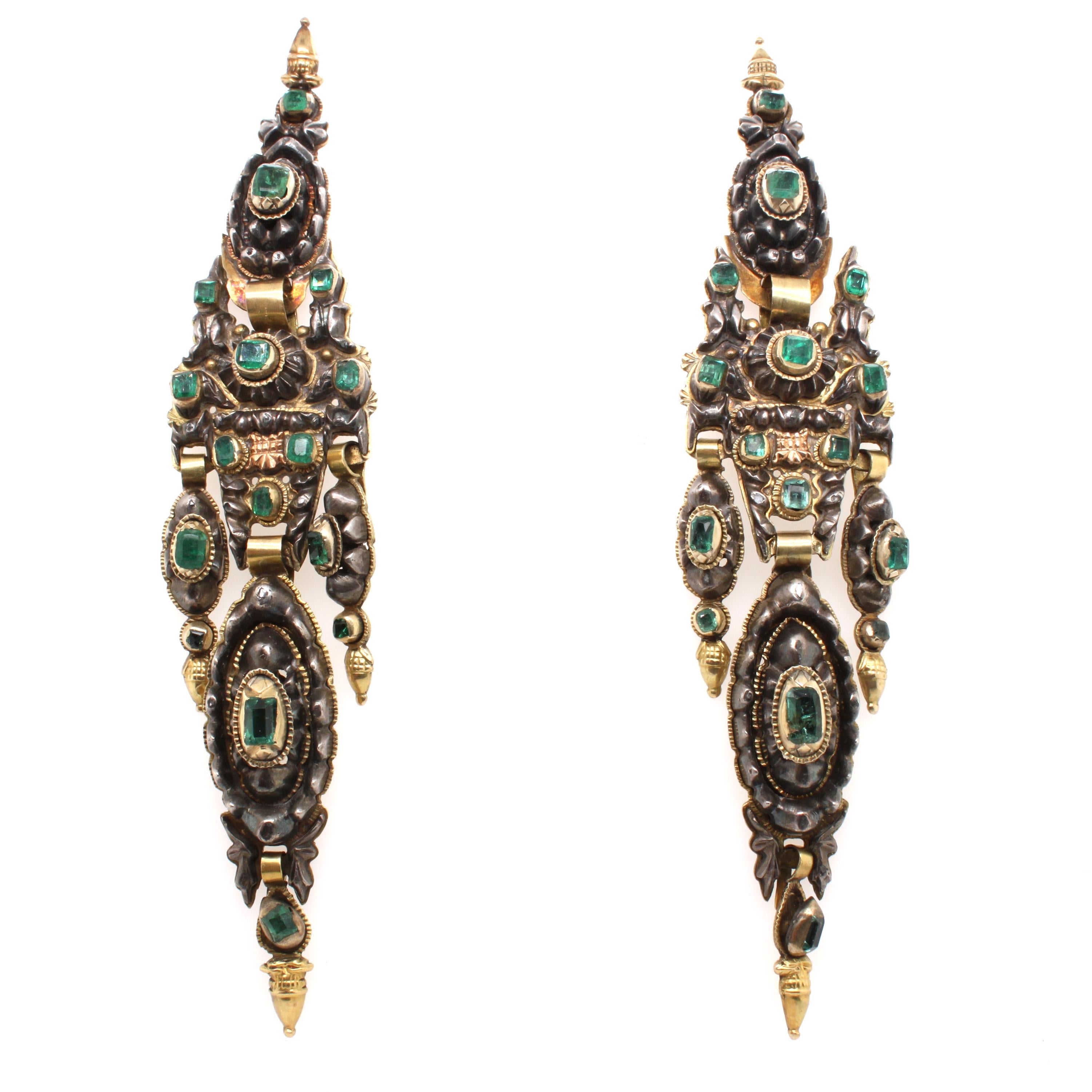 Antique Iberian Emerald Earrings, ca. 18th Century

A rare pair of antique Iberian - Portuguese earrings in yellow gold and silver, studded with Colombian emeralds. The chandelier earrings have several moving links and are of a long length, which