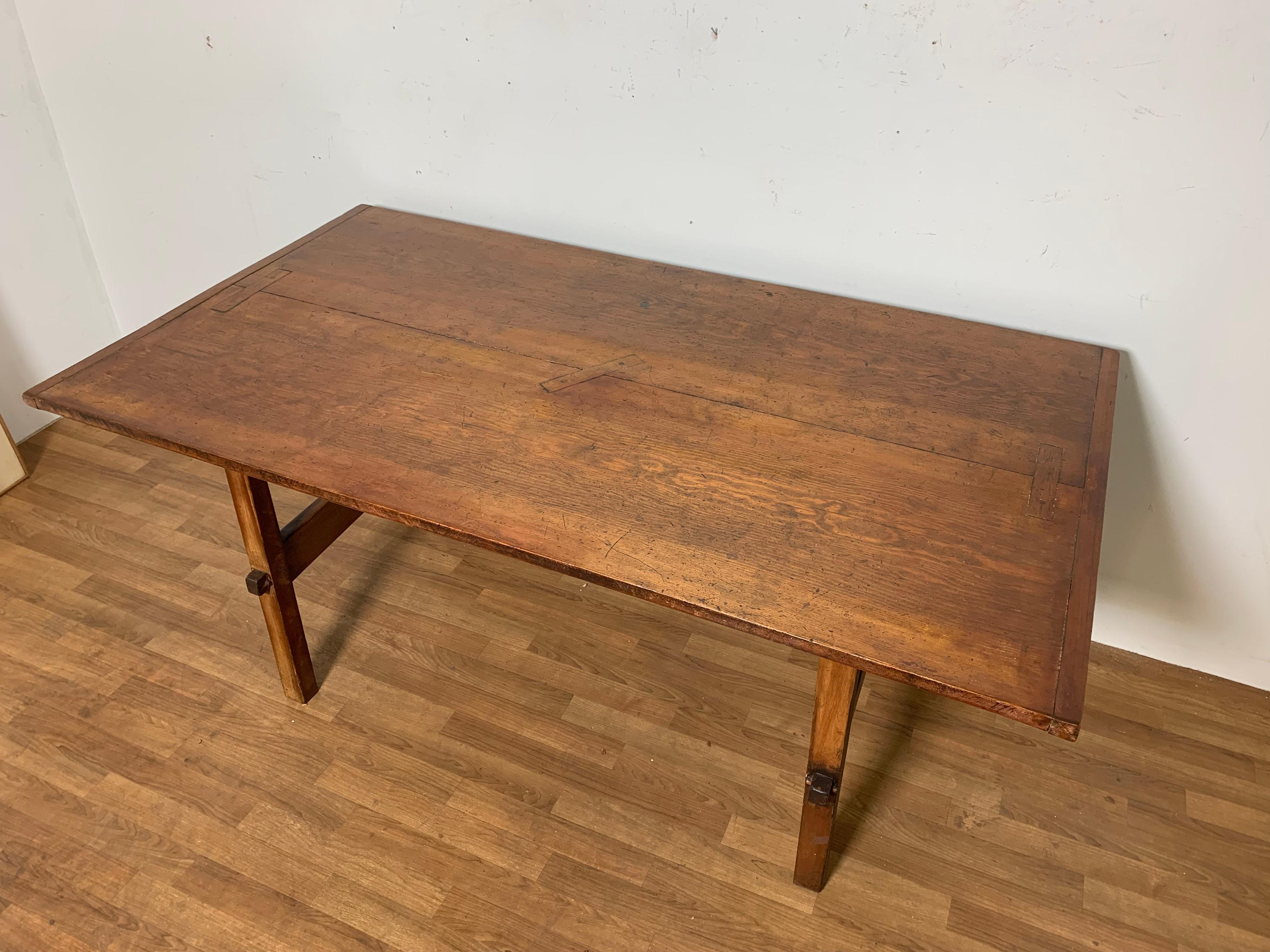 An exceptional 18th century pine farm table from the historic Baker-Sutton House in Ipswich Massachusetts features two wide pine boards of exceptional amber color with key joinery and breadboard ends. The top is of early New England construction,