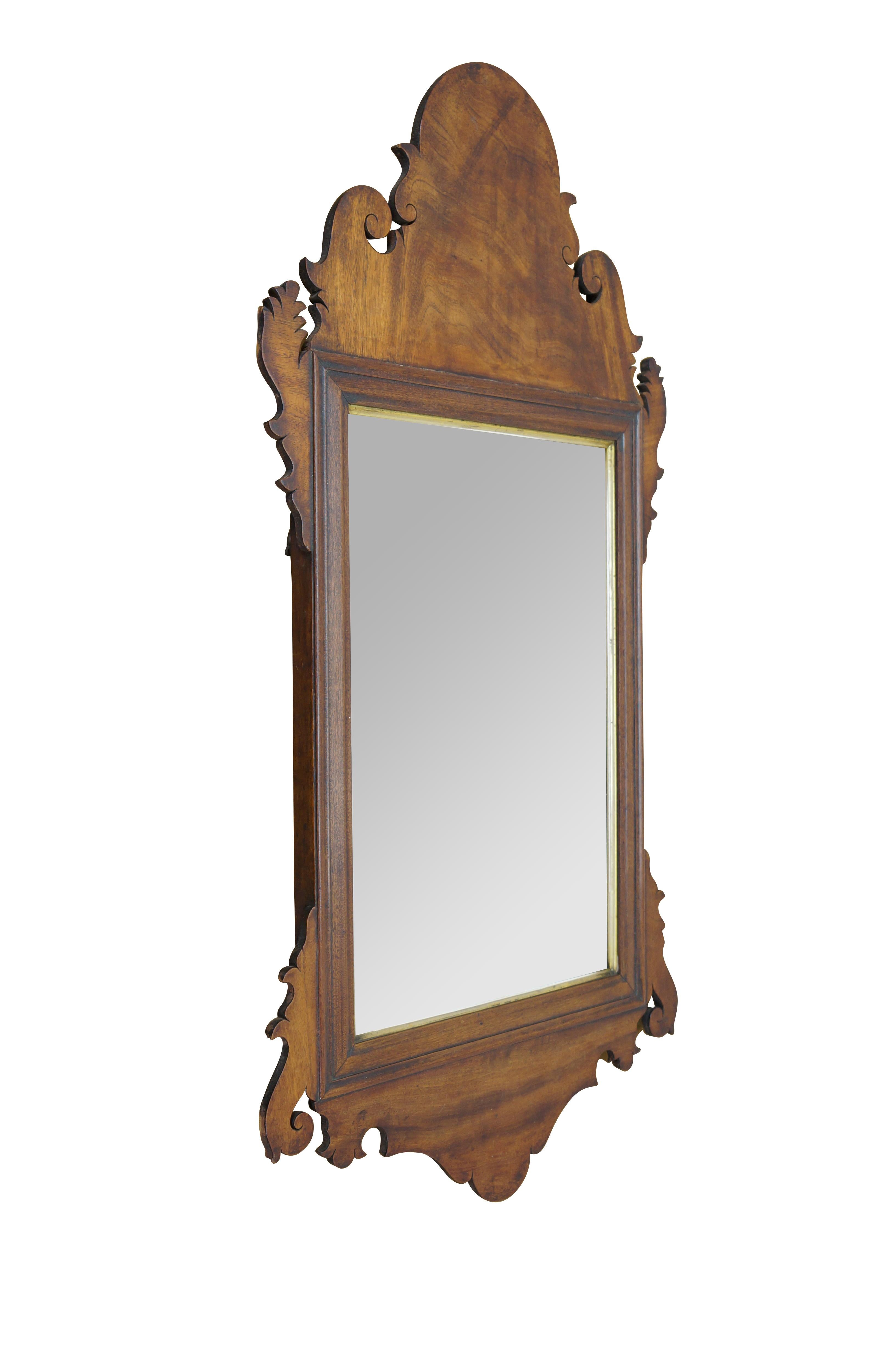 Antique 18th century Chippendale wall mirror attributed to John Elliot & Sons of Philadelphia.  Features a beveled frame accented with broad carved fret and a gilt inner edge. 

Dimensions:
17.75