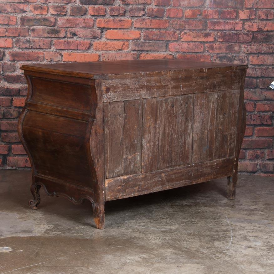 This stunning large chest of 4 drawers has dramatic curves and beautiful hand carved details to accentuate the romantic lines of the chest. The deep, rich patina of the chestnut is captivating after 200 years of use. If you appreciate French