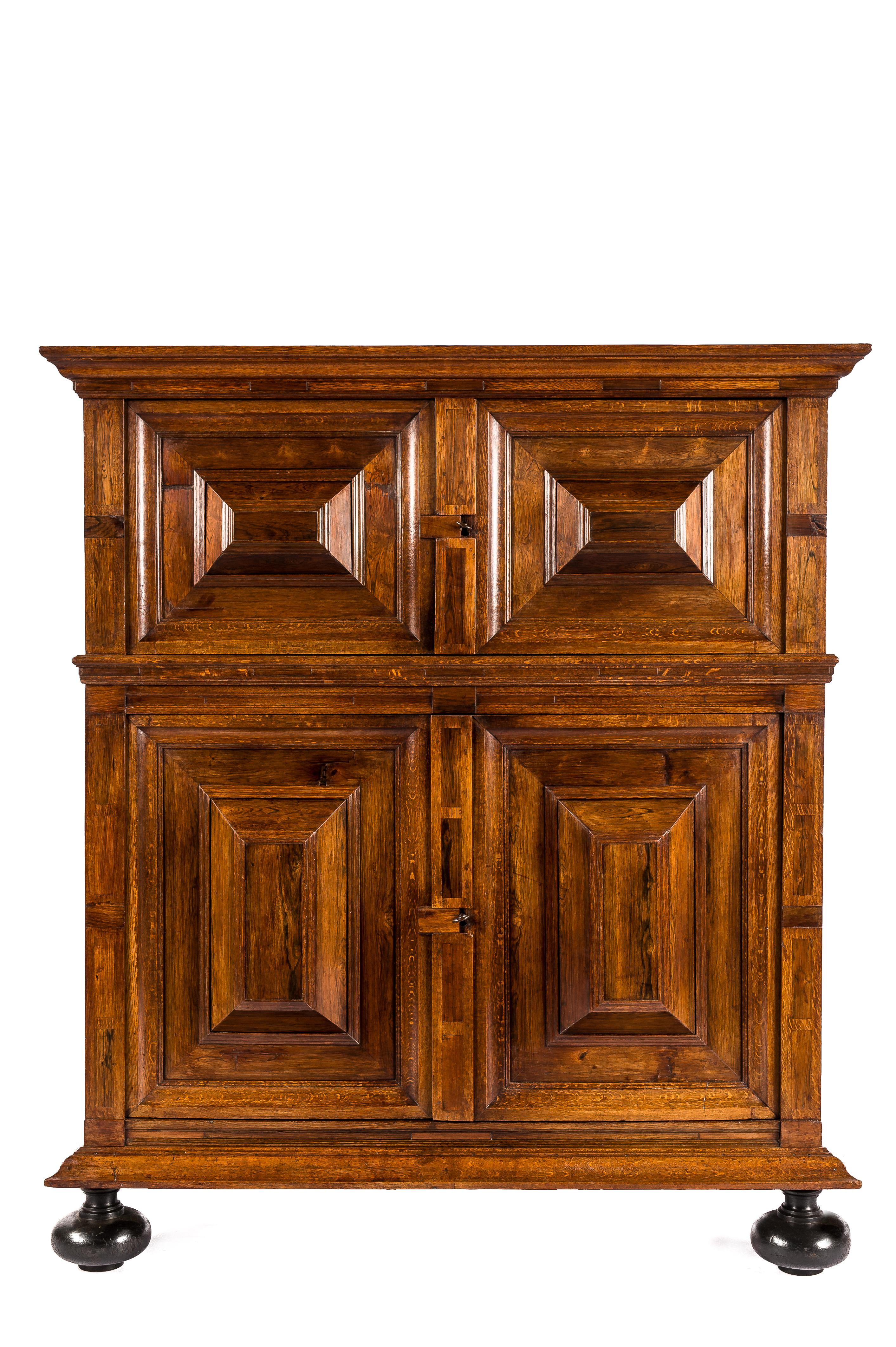 A beautiful early 18th-century four-door Renaissance cupboard in the best quality solid oak and walnut veneer. The cupboard boasts a warm honey color combined with deep gloss and a rich patina built up over 300 years. This is a  'kussenkast' or