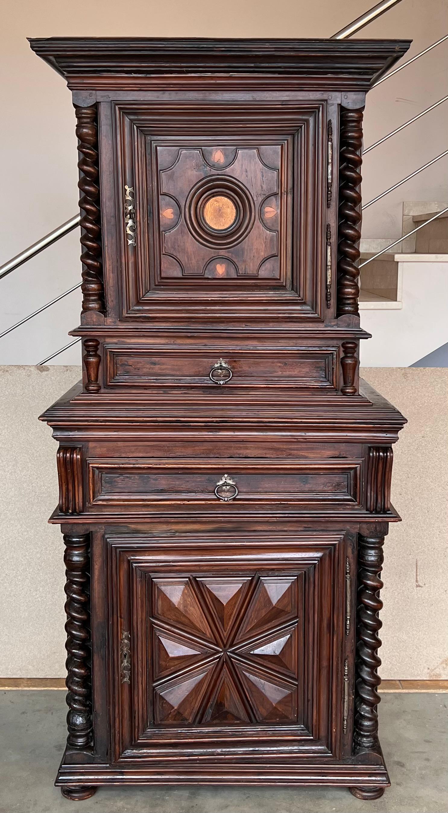 An exquisite Dutch cushion cabinet with two doors and two drawer. This cupboard takes its name from the pillow-shaped thickenings on the doors. The doors are flanked by semicircular ebony veneered columns. In the middle sits a curved drawer. 
This