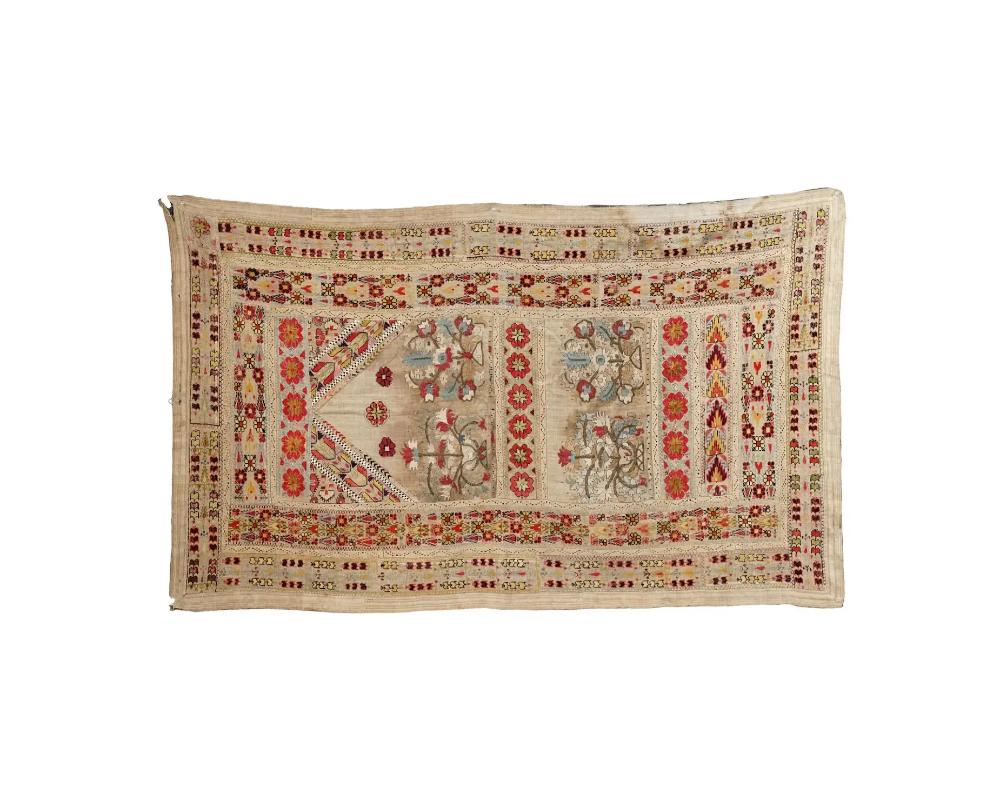 An antique Turkish hand-emboridered textile tapestry. Ottoman Empire, 18th century. A large rectangular piece intended for wall hanging. The item is richly garnished with delicate handmade floral cross stitch embroidery creating a pattern.