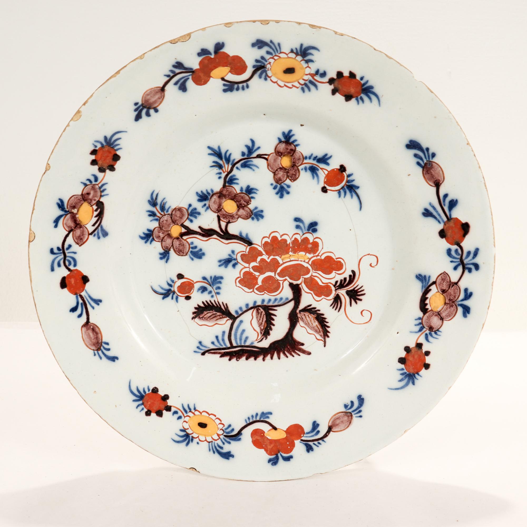 A fine antique 18th century Dutch Delft plate.

With painted floral decoration throughout in orange, purple, blue, and yellow.

Simply a wonderful Dutch Delft plate!

Date:
Mid-18th Century

Overall condition:
It is in overall fair,
