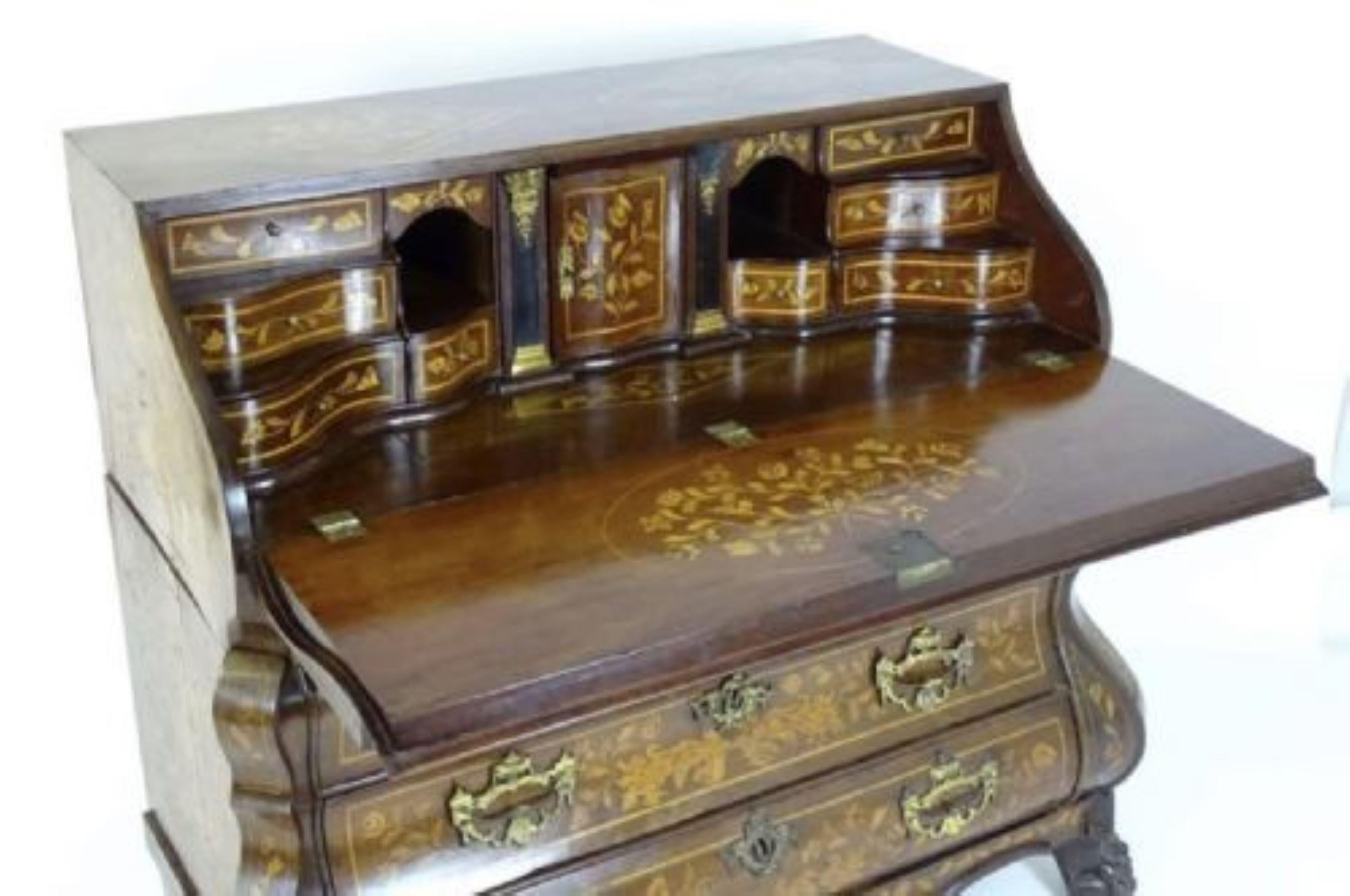 Antique 18th century quality Dutch burr walnut floral marquetry bureau.
18th century Dutch marquetry bombe shaped bureau having a serpentine shaped fall opening to reveal a fantastic serpentine shaped interior consisting of ten drawers, pull out
