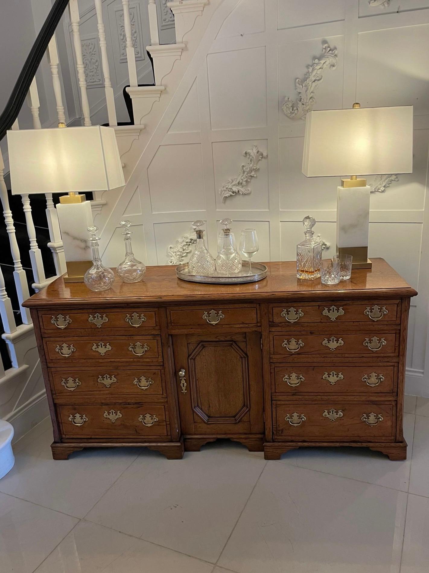 Antique 18th century George III quality oak dresser base with original brass handle & escutcheons having a first class quality oak rectangular shaped top with a moulded edge above nine oak drawers with original brass handles and escutcheons, single