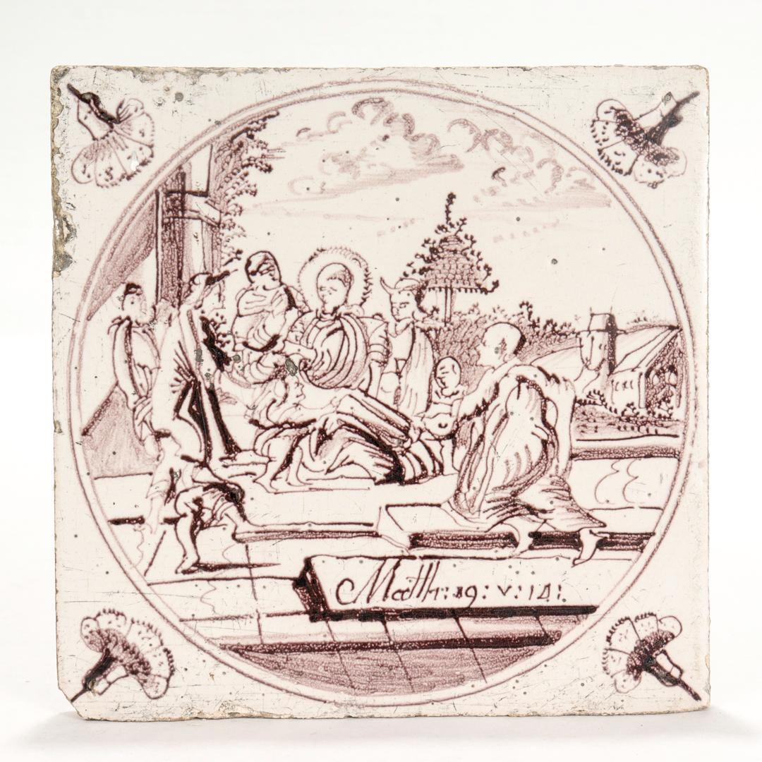 A fine antique 18th century Dutch Delft pottery tile.

With the Biblical scene of Christ with a group of children from Matthew 19:14 in manganese decoration. 

The scene depicts the story from Matthew in which the disciples of Jesus attempt to