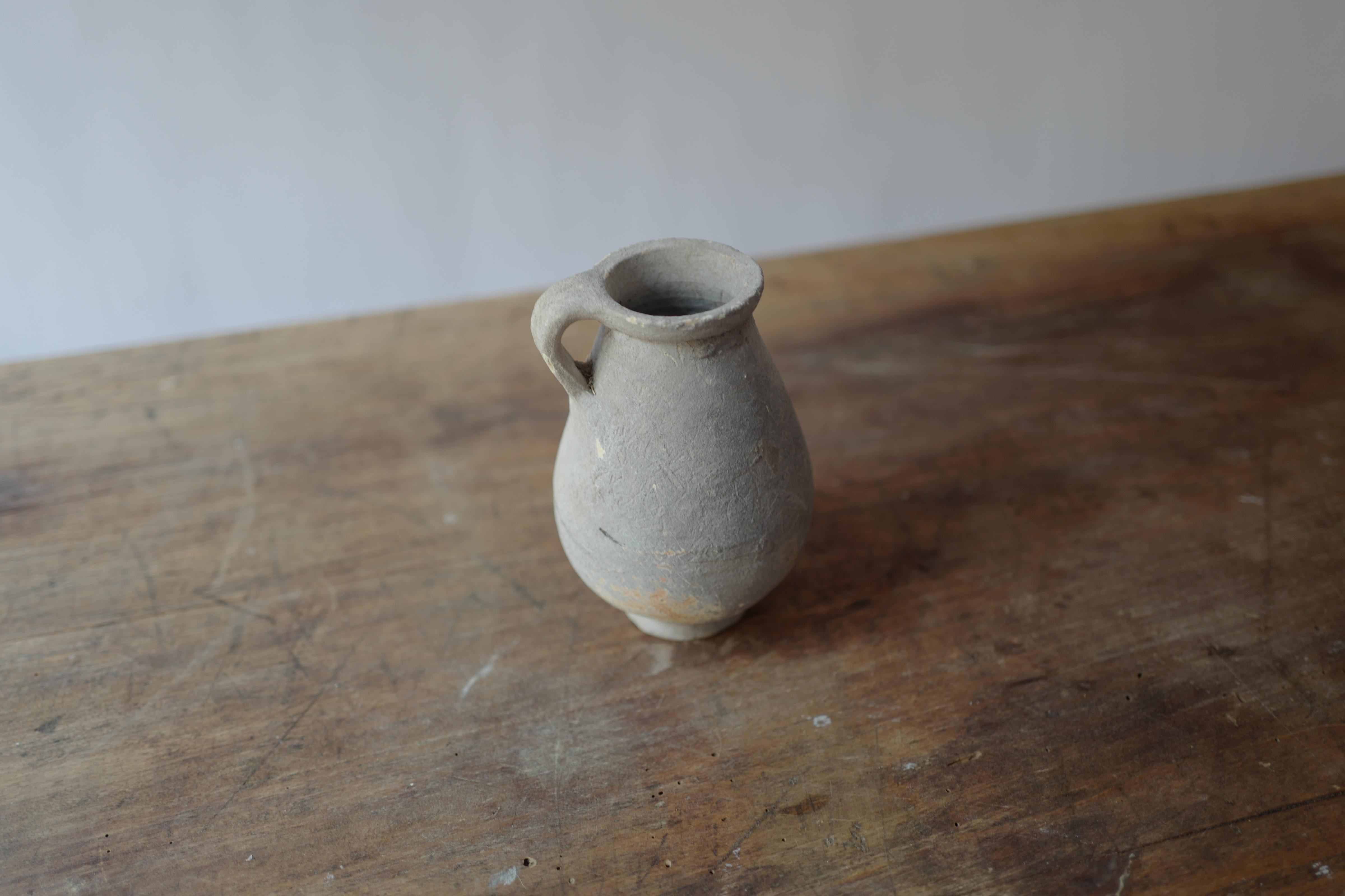 Discover the rustic beauty of this Antique 18th Century Roman Tunisian Grey Pot, a handcrafted terracotta vessel that blends Roman design influences with traditional Tunisian craftsmanship. Featuring a subtle grey finish and elegant form, this pot