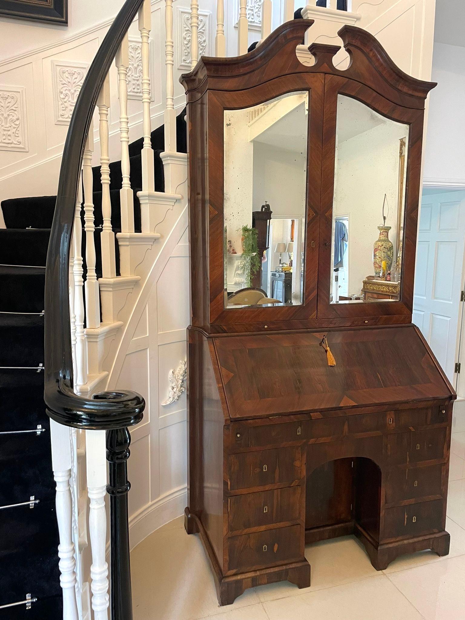 Antique 18th century rosewood bureau bookcase having a magnificent top section with a shaped moulded swan neck pediment, two shaped doors both with original mirrors which open to reveal the most superior quality fitted interior of drawers, pigeon