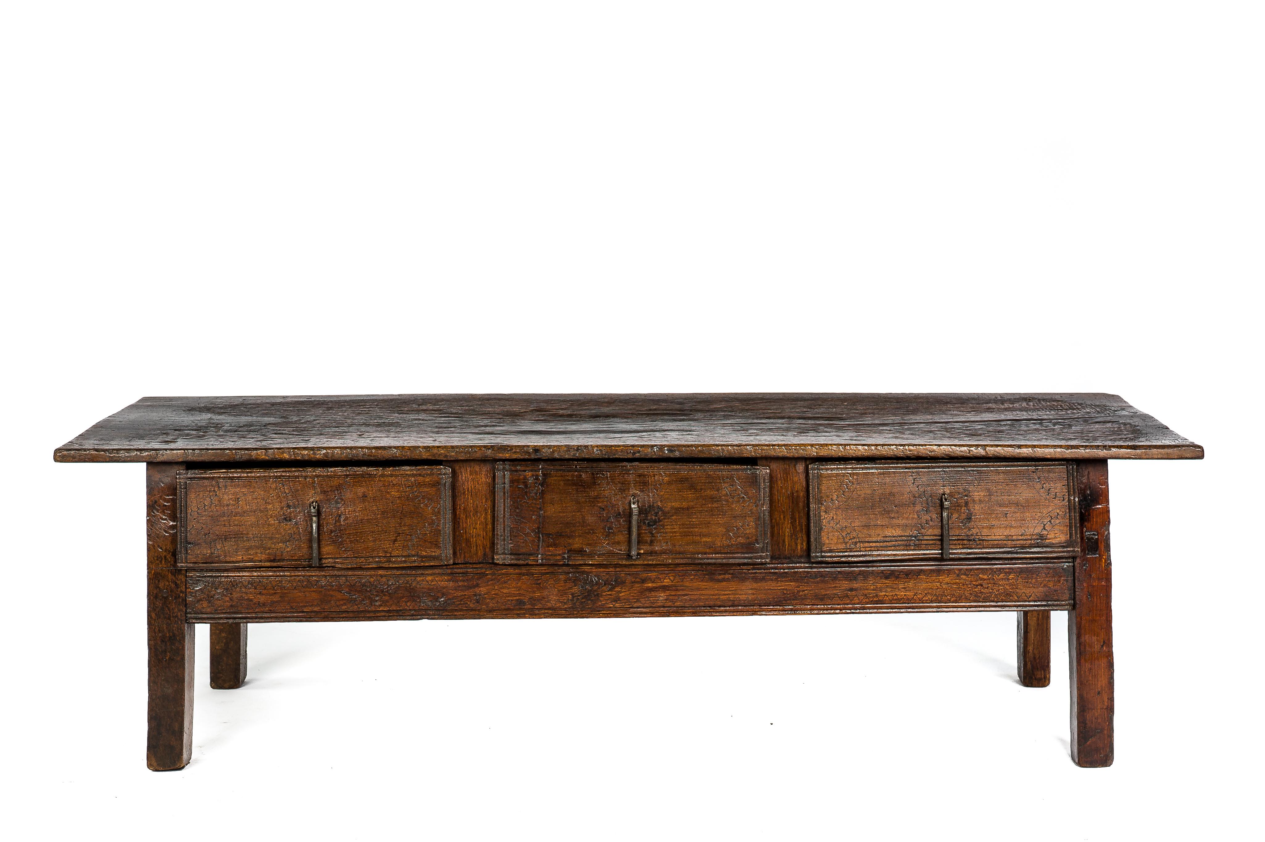 This beautiful warm brown color rustic coffee table or low table originates in rural Spain and dates circa 1725. The table has a fantastic worn top that was made from a single board of solid chestnut wood 1 inch thick. The top is very distressed and