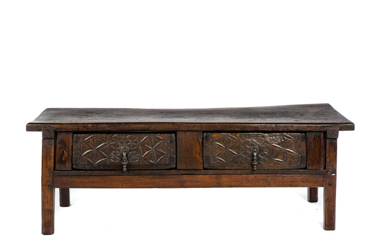This beautiful dark brown rustic coffee table or low table originates in Spain and dates circa 1750. 
The table has a beautiful top that was made from one single board of solid chestnut wood of 1,58 inches thick. 
The top has a beautiful patina
