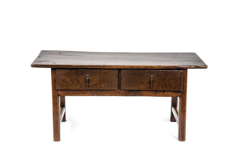 This beautiful warm brown color rustic coffee table or low table originates in Spain and dates circa 1800. The table has a great somewhat tapered top that was made from a single board of solid chestnut. The top has a beautiful grain pattern with