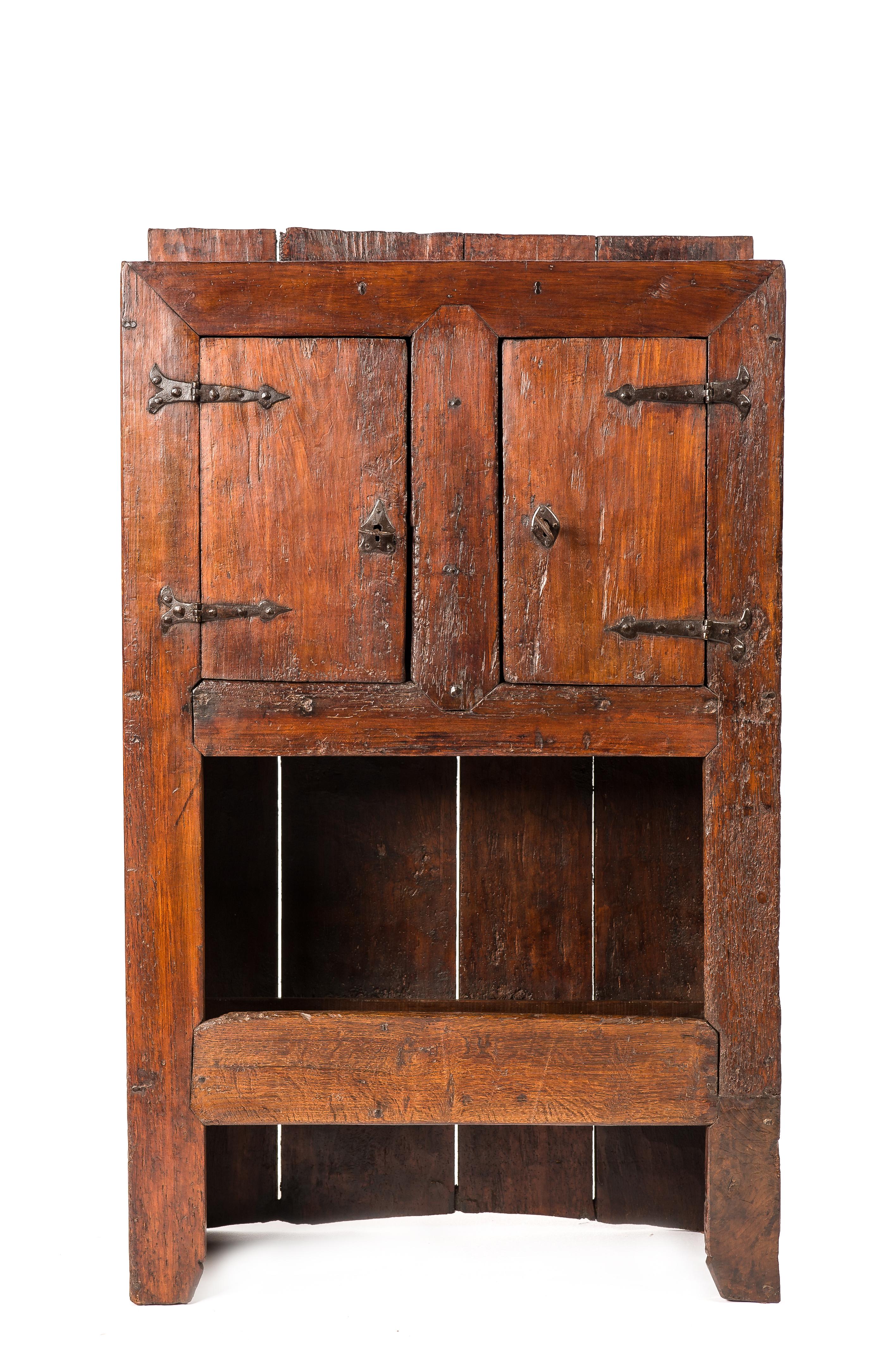 This beautiful rustic cabinet was made in rural Spain in the early 18th century circa 1720. 
Its sleek appearance with all the wood jointing exposed displays the purity of the design and the craftsmanship of its maker. It was almost completely made
