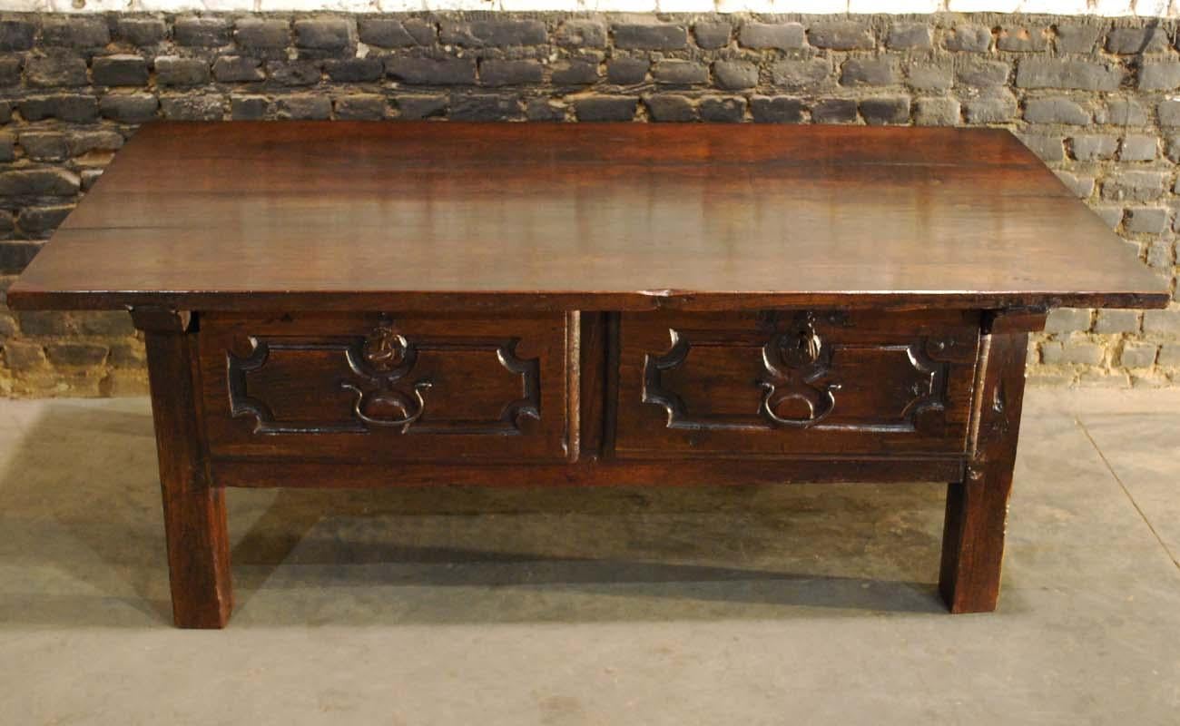 A beautiful mid-18th century low table that originates in Spain.
It has the rural and rustic feel of ancient Spanish furniture. The top is made of two pieces of solid chestnut timber and it is attached to the base by the use of dovetail