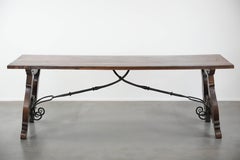 Antique 18th-century Spanish dining table with a wrought iron base